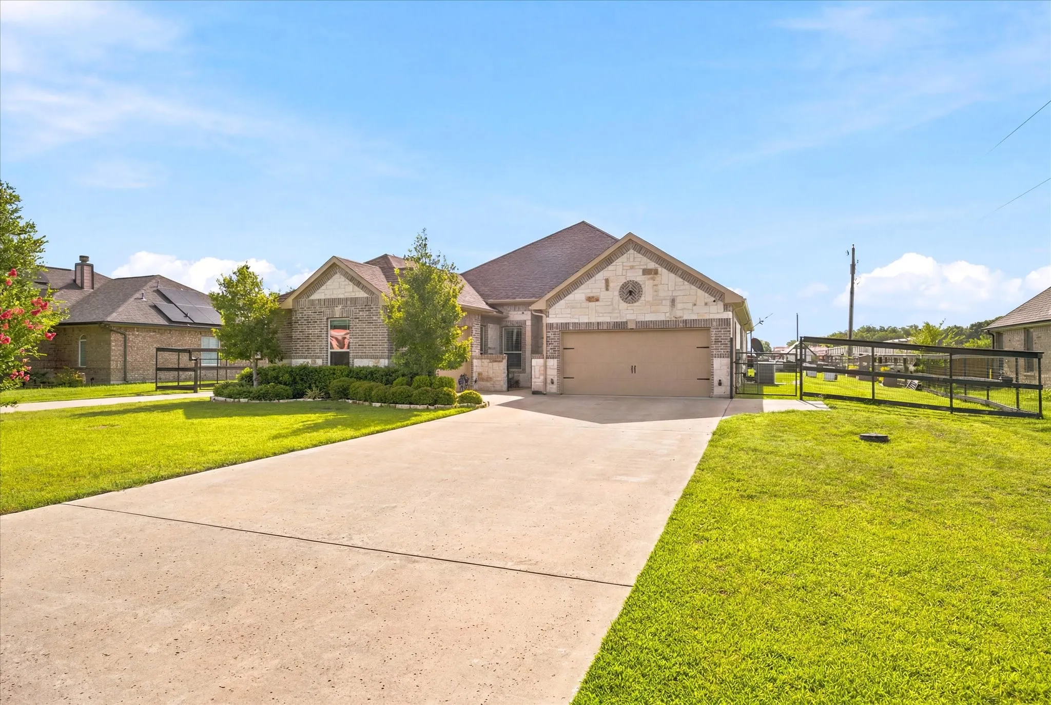 Brick and stone veneer exterior with a three- car garage