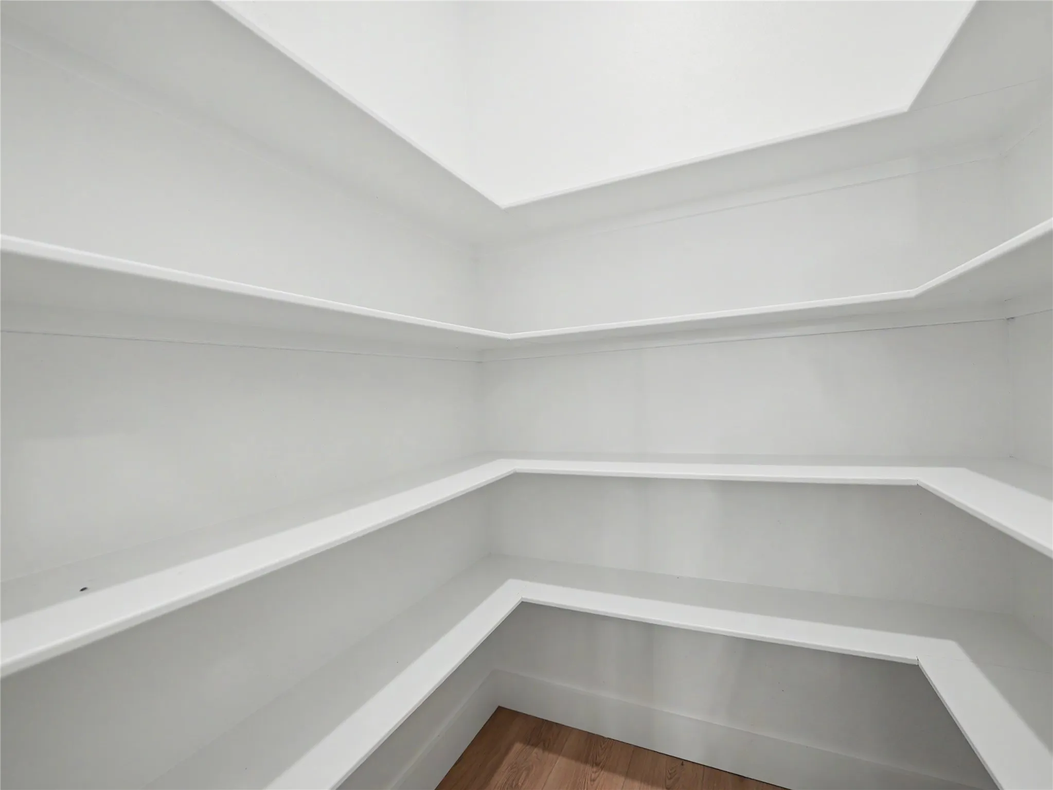 Built-in shelving with multiple tiers and white finishes