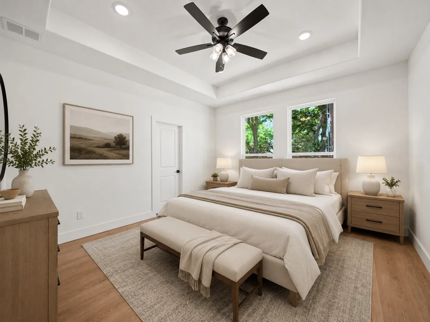 Bedroom featuring a tray ceiling with recessed lighting and a ceiling fan