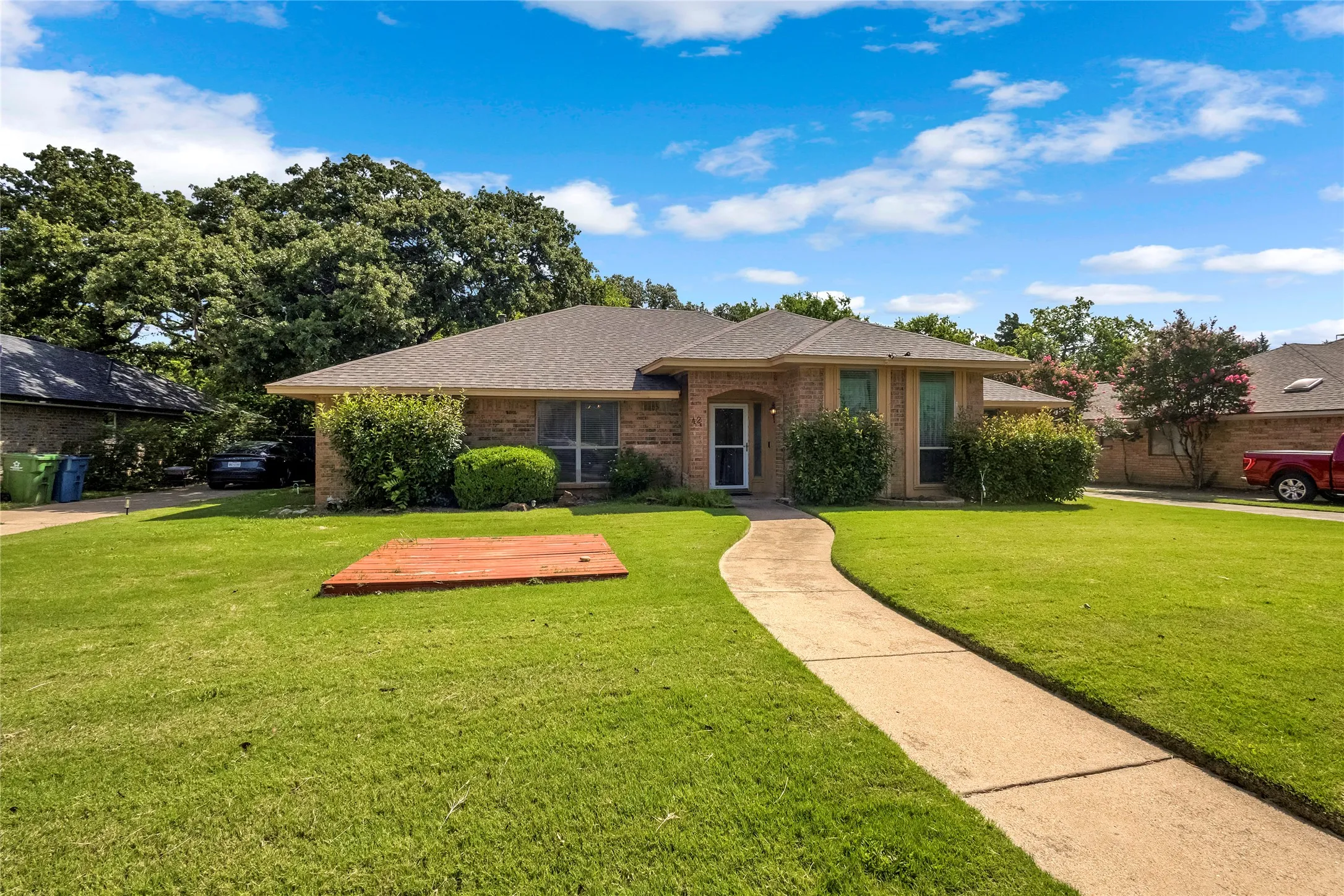 Single-story brick exterior with a dark shingle roof