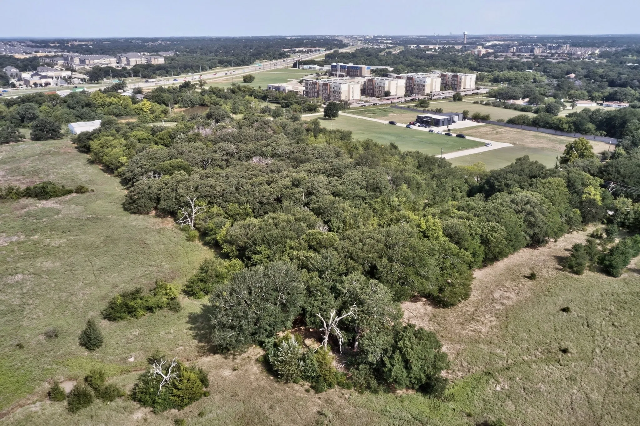 Expansive acreage featuring mature trees and open grassy areas