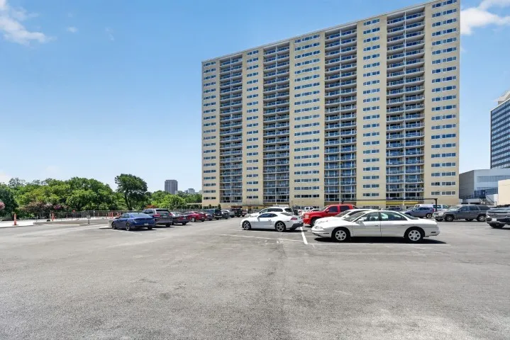 Multi-story residential building featuring numerous private balconies