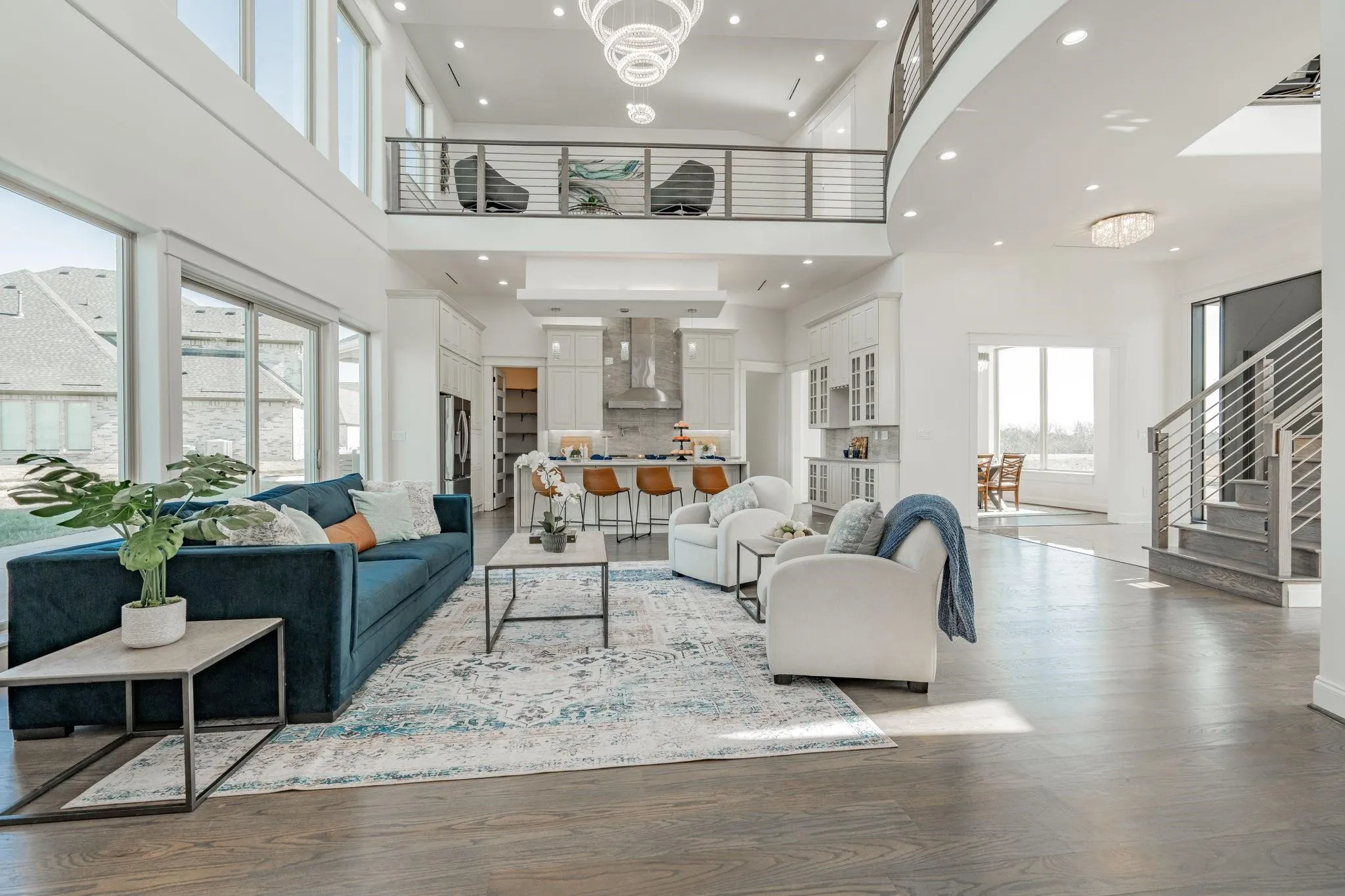 Open-concept living area with soaring ceilings and expansive windows