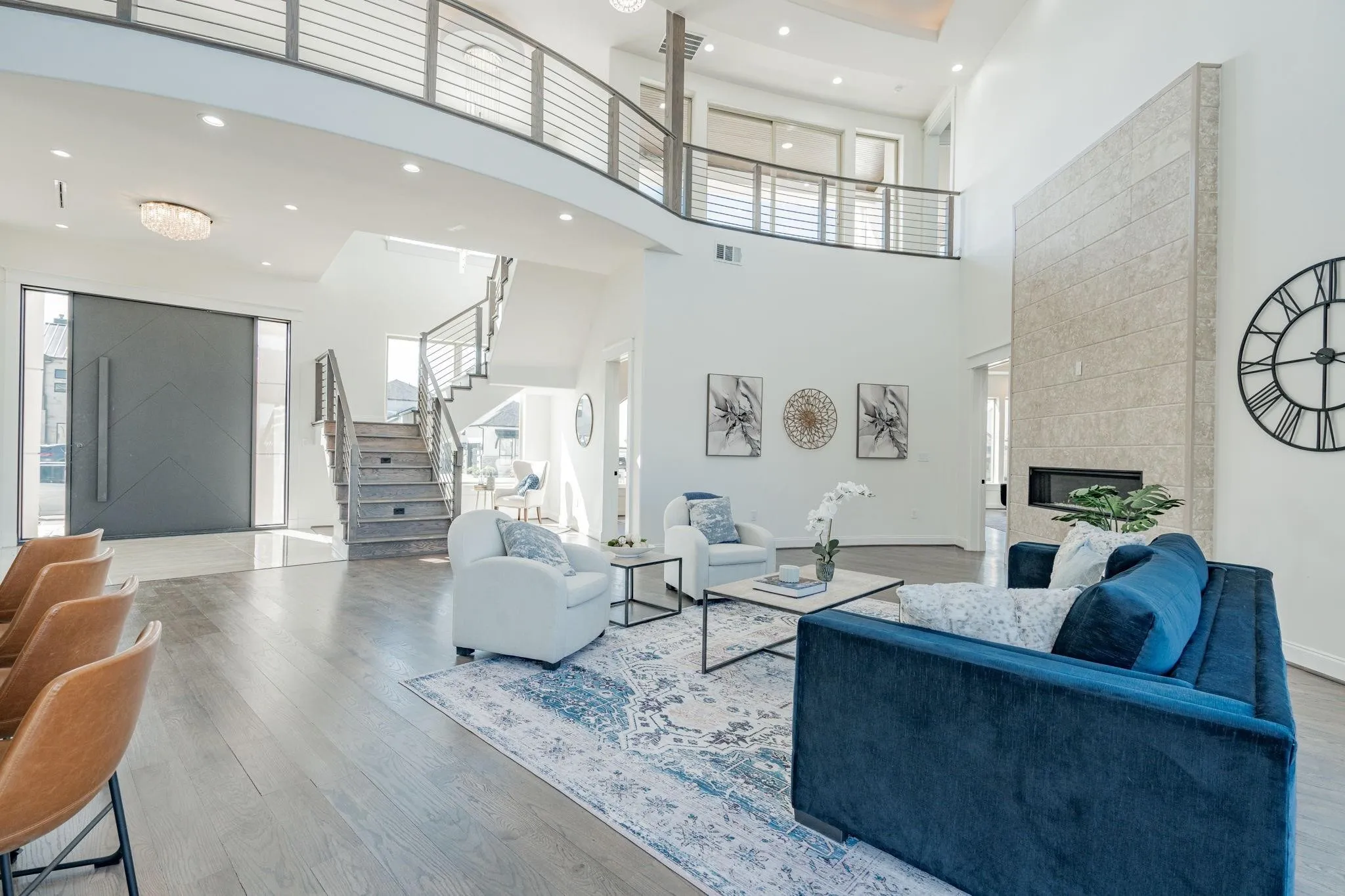 Spacious foyer with a grand entry door and light wood-finish flooring