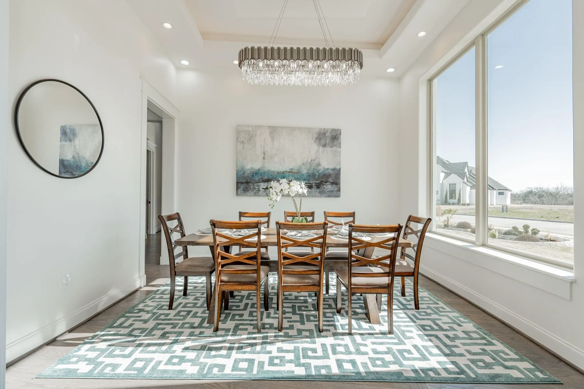 Dining area featuring a coffered ceiling, a contemporary chandelier, and recessed lighting