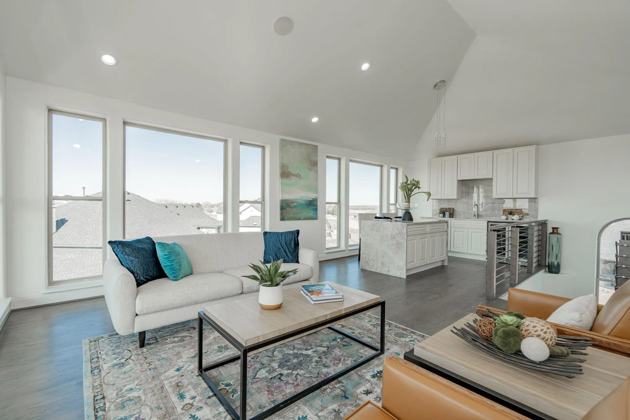Open-concept living space featuring high vaulted ceilings, recessed lighting, and a wall of windows
