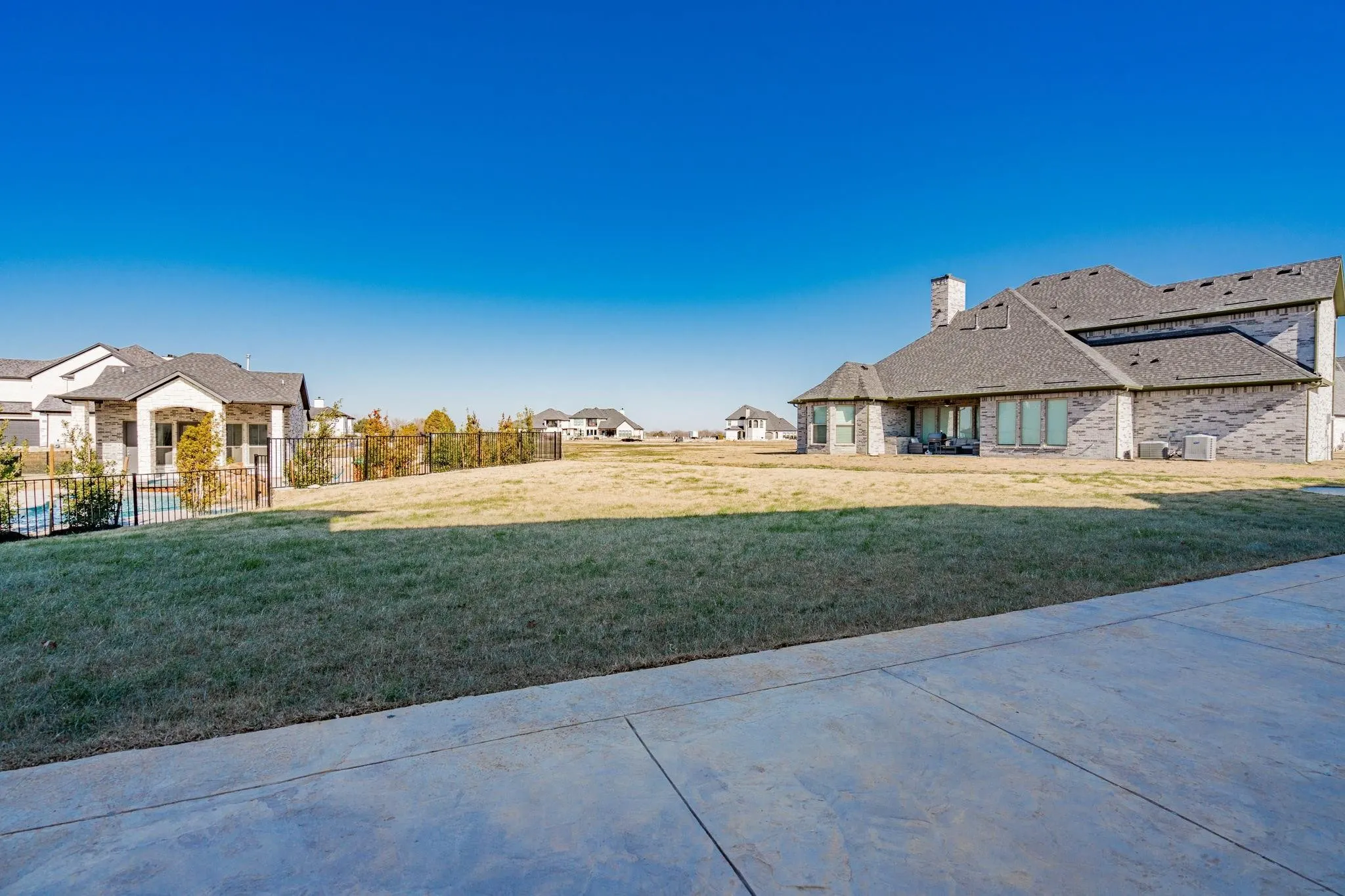 Expansive lawn with a concrete patio
