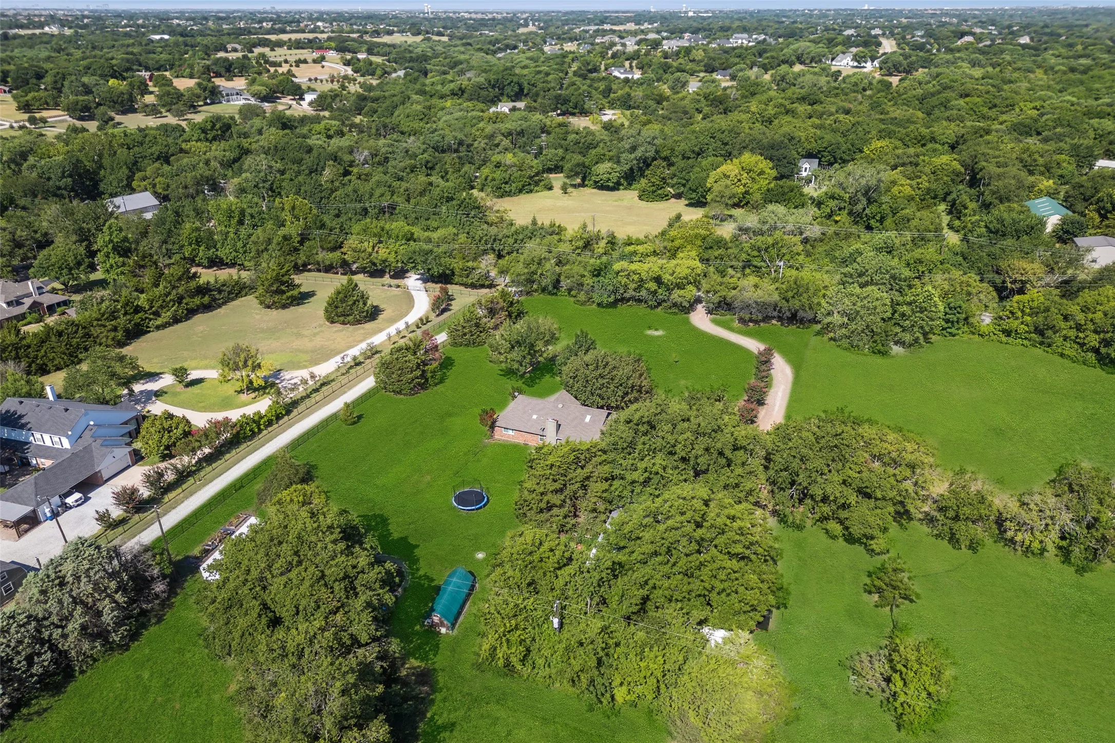 Expansive property featuring a single-story residence with a brick exterior