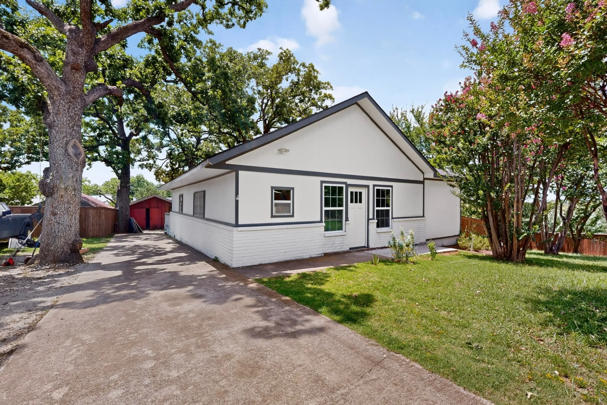 Contemporary white siding and white brick exterior with dark trim