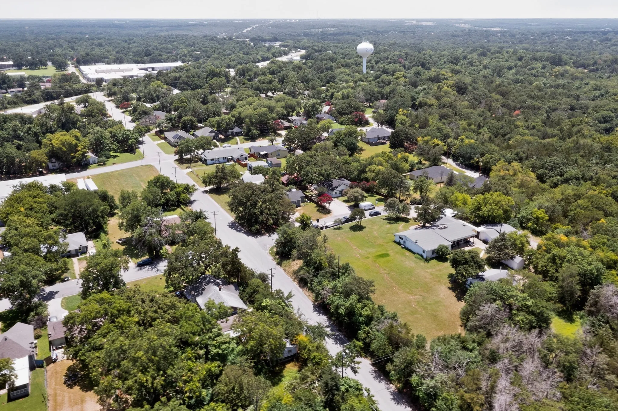 Aerial view showcasing a residential area characterized by mature tree coverage