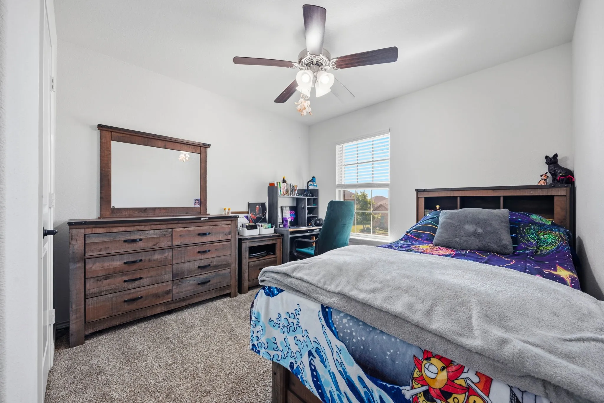 Carpeted bedroom featuring a ceiling fan with light fixture, window with blinds, and white walls