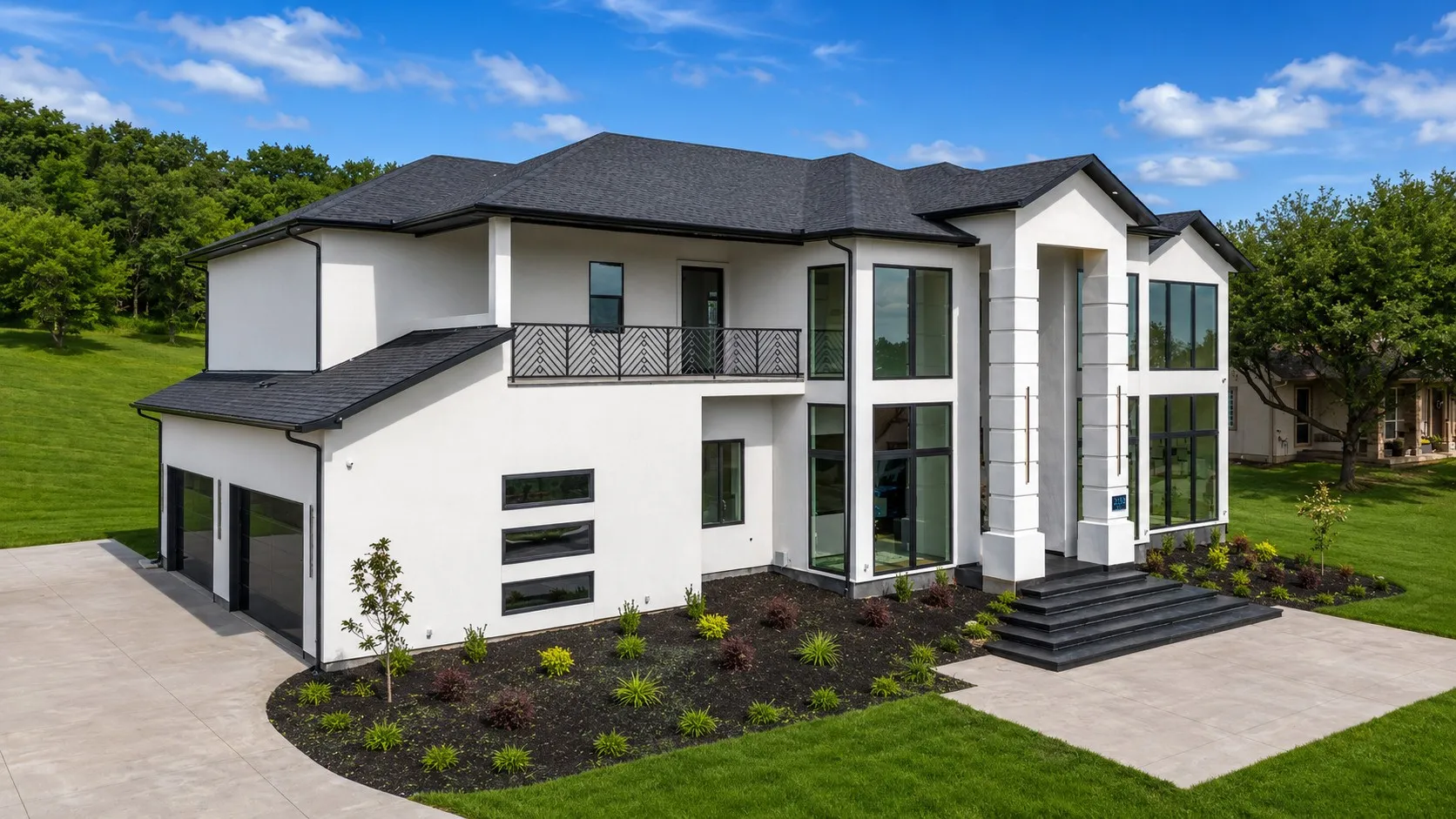 Contemporary residence featuring a white stucco exterior and a dark shingle roof