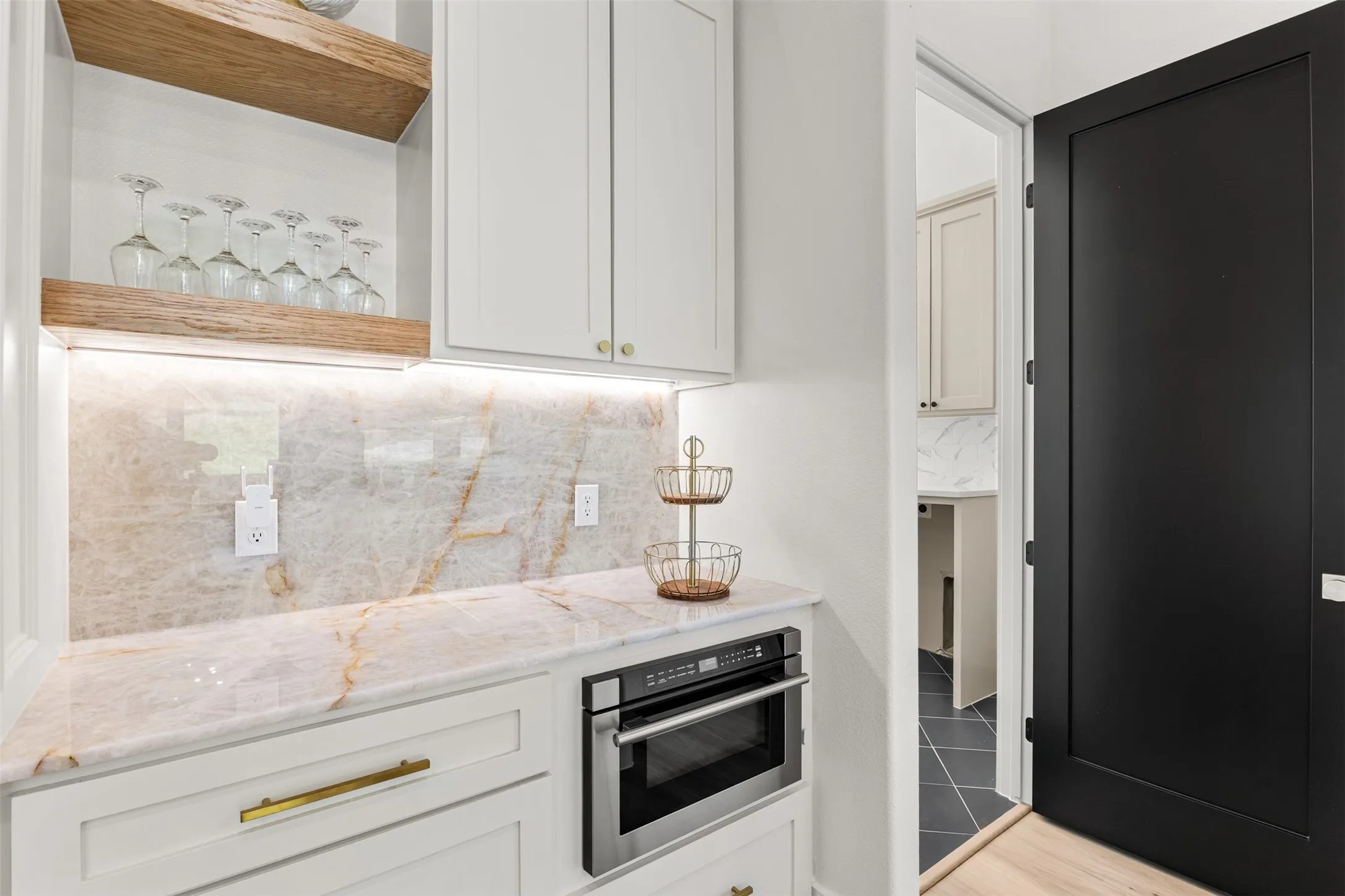 Built-in cabinetry with marble-look countertops and backsplash