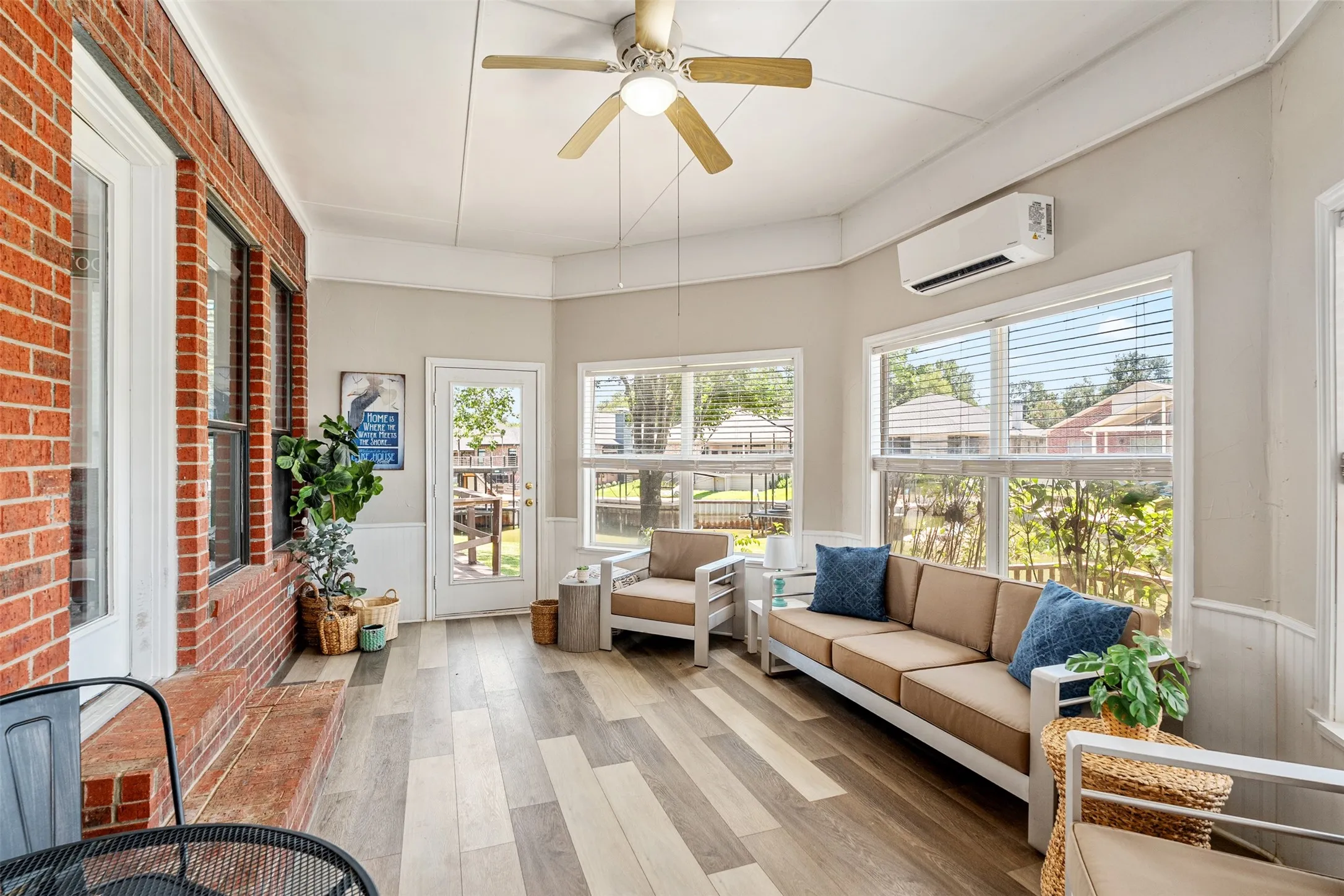 Sun room or game room with natural light and lake views.