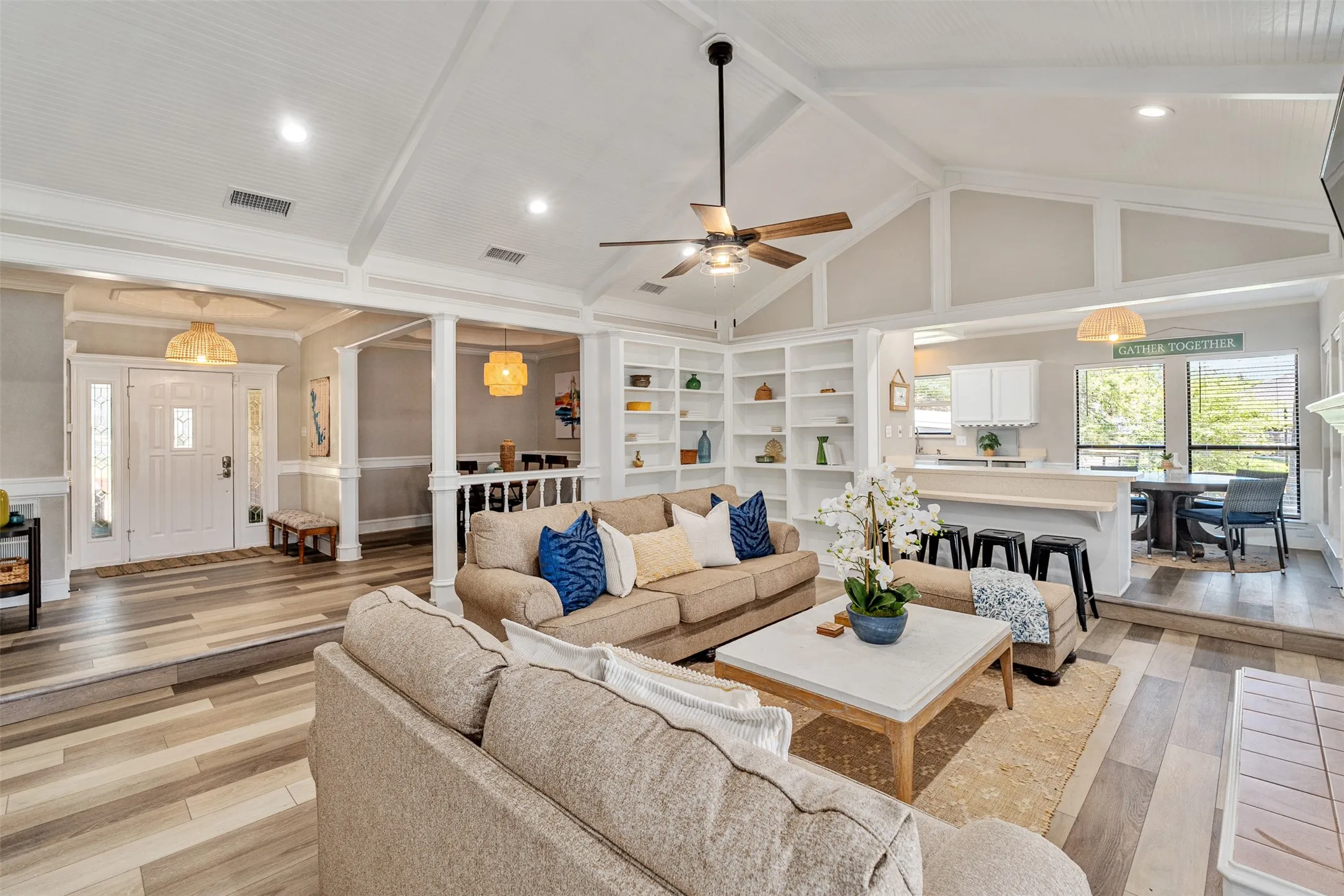 Living room with built-in shelving, vinyl flooring, open plan and lake views