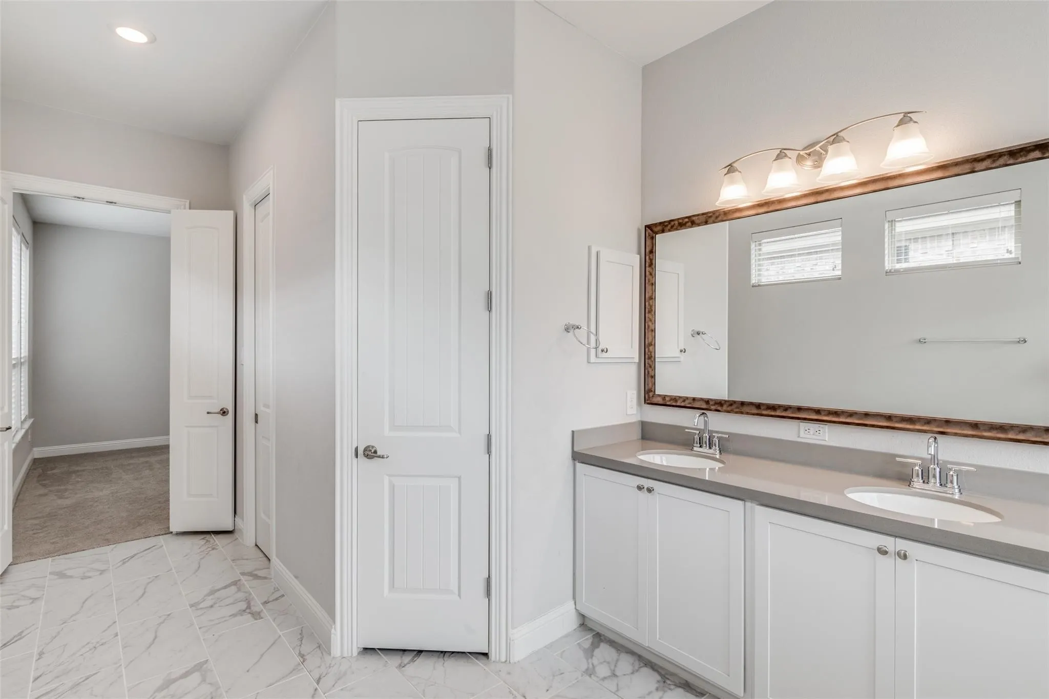 Dual vanity with undermount sinks and gray countertops