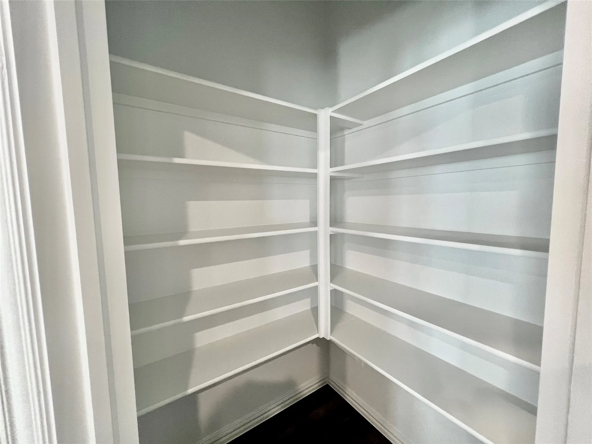 Built-in shelving unit featuring multiple white-painted shelves