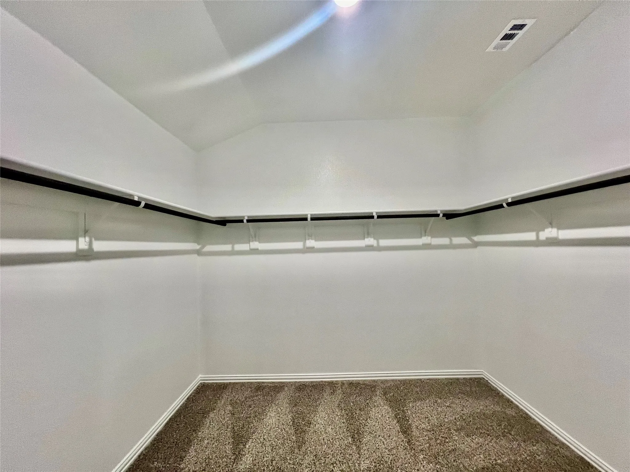 Neutral-toned carpeting paired with white baseboards