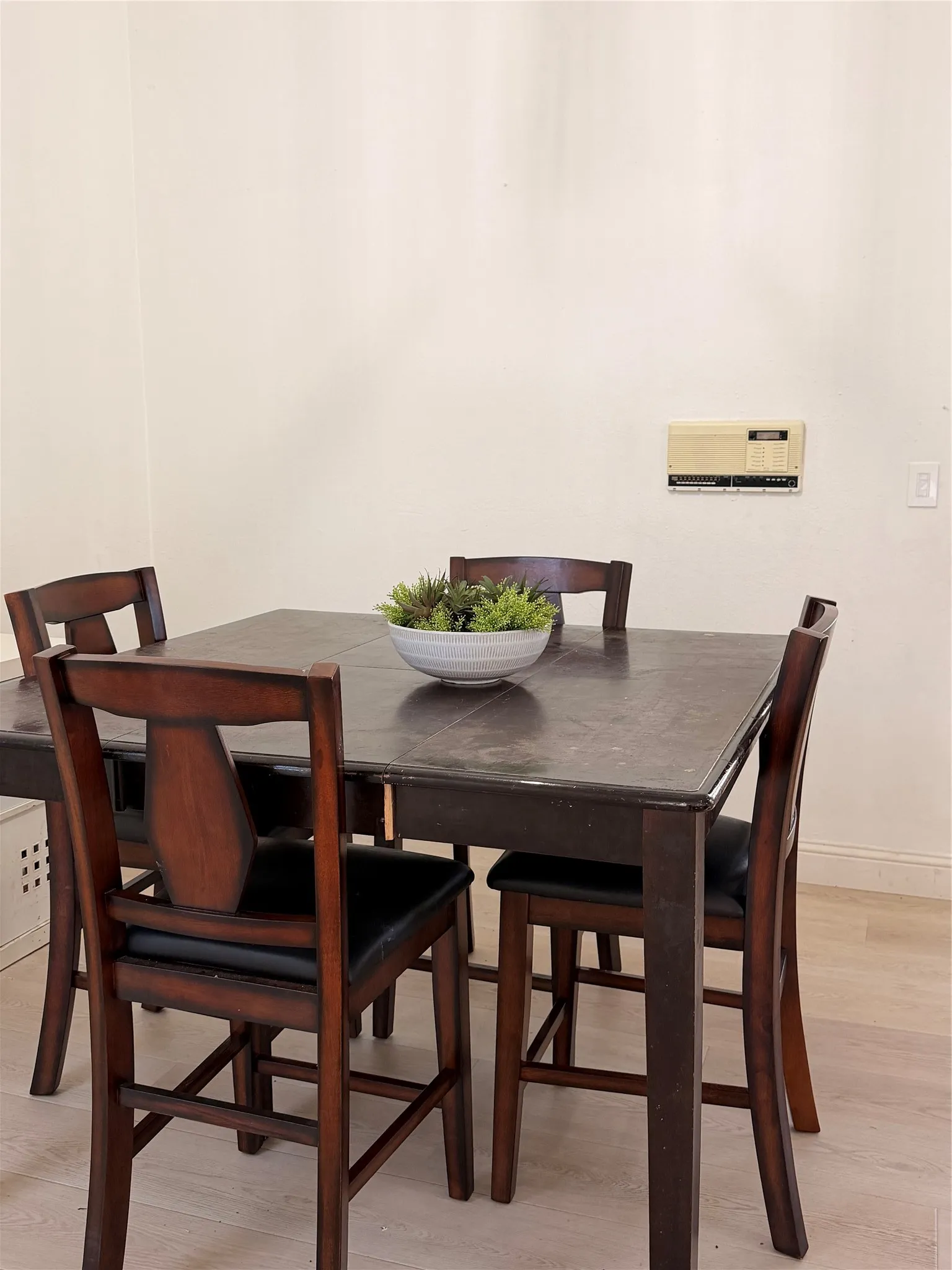 Light-toned wall surfaces and wood-finish flooring provide a neutral backdrop