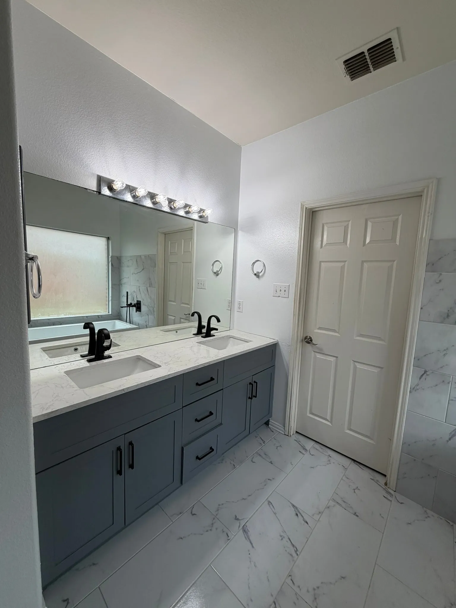 Dual vanity with white quartz countertop and integrated rectangular sinks