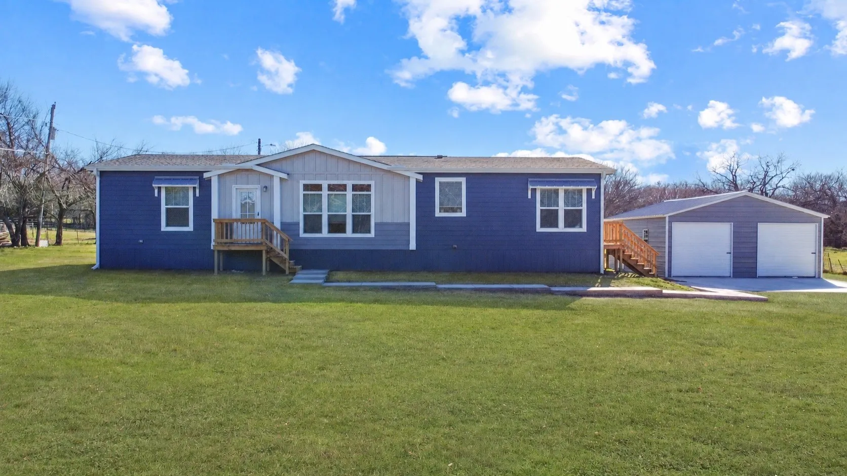 Front of home with a large grassy area for recreation.
