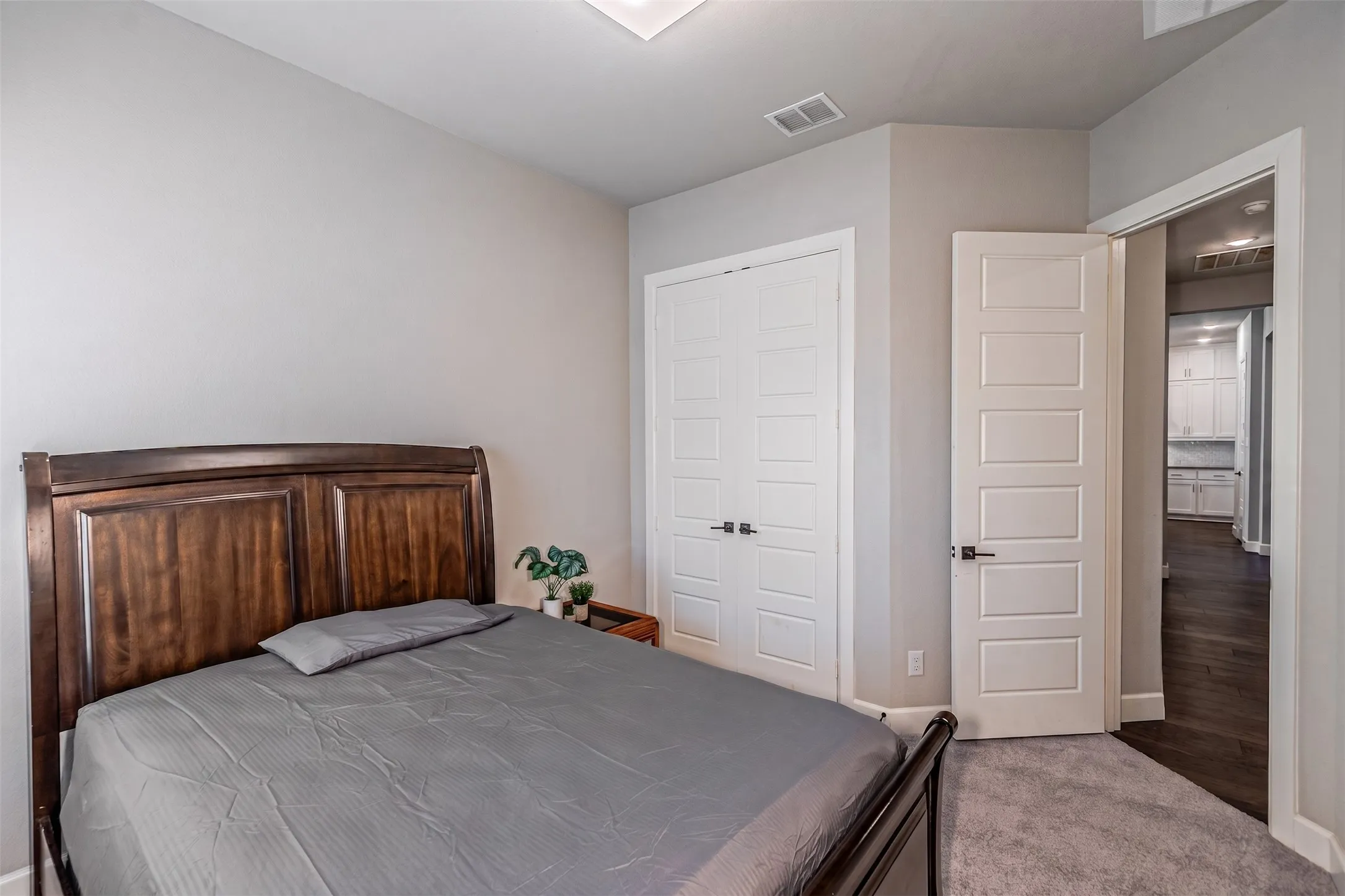 Plush carpeting, paneled closet doors, and a five-panel interior door