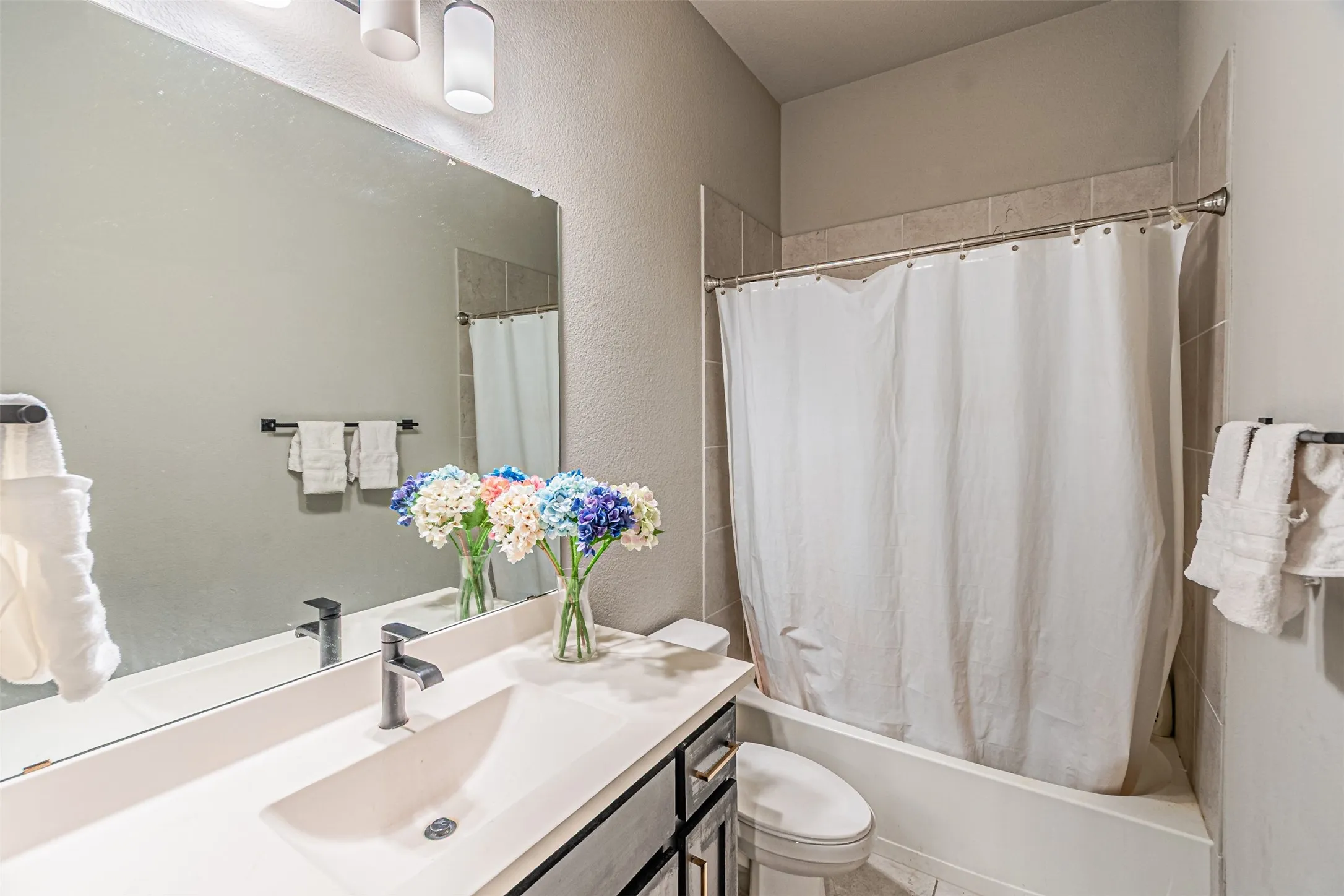 Built-in vanity with integrated sink, rectangular mirror, and three-light fixture