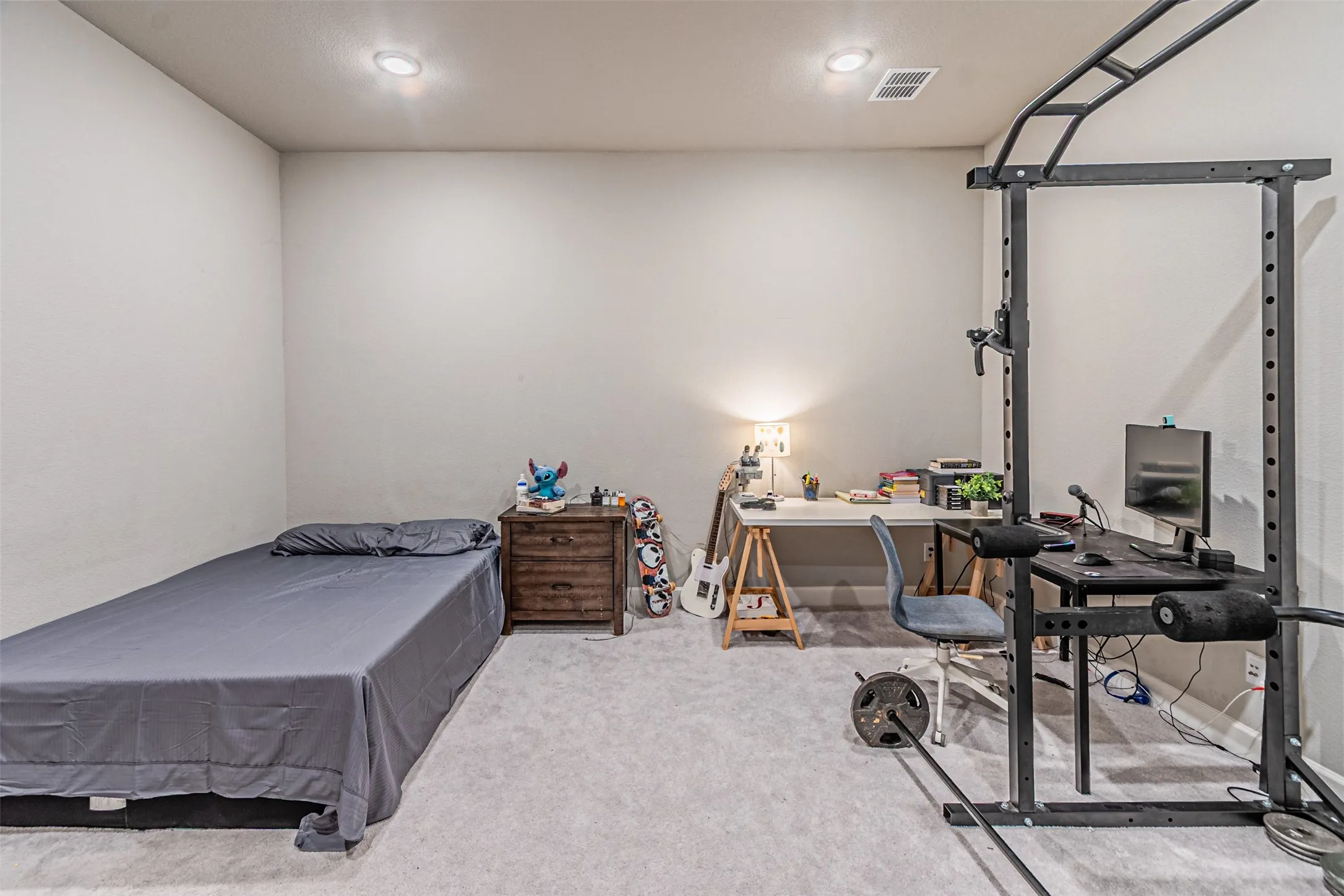 Recessed lighting, light-toned carpeting, and neutral wall tones