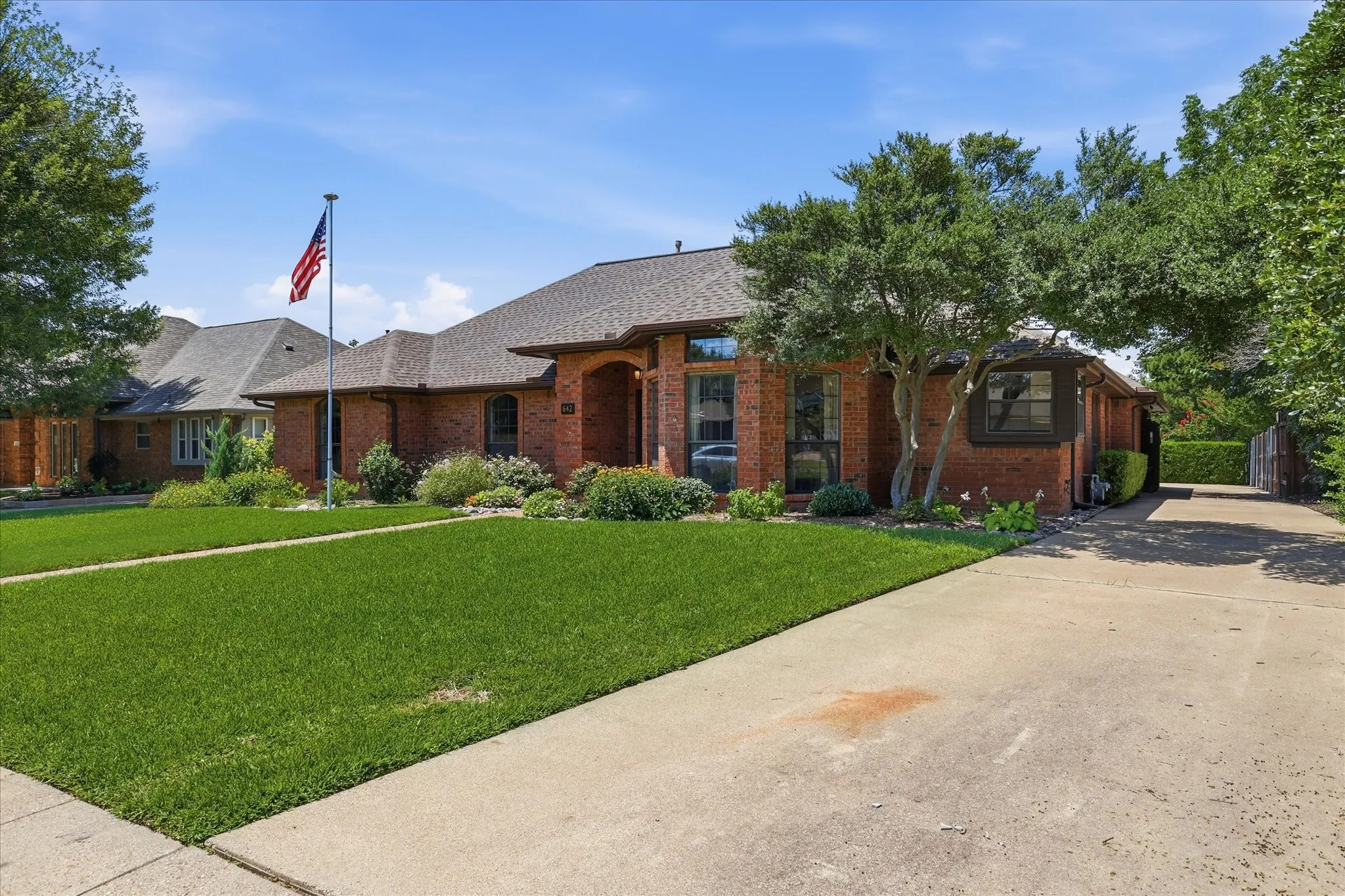Long driveway with swing in parking in the back and an electric gate.
