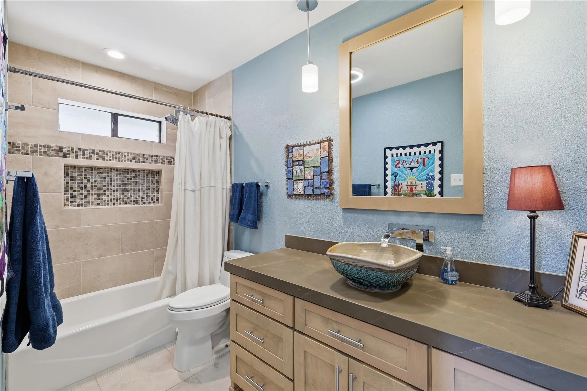 This hall bath was remodeled in recent years.  The tub area offers a spacious niche for all the bath products.