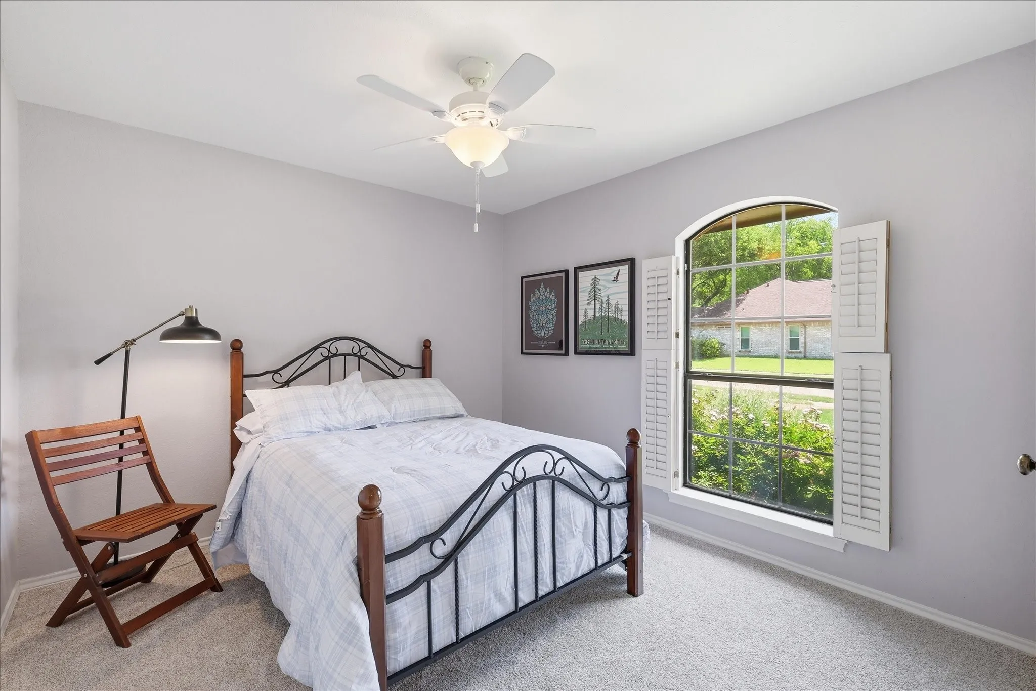 Bedroom 3 with walk in closet and ceiling fan.. The shutters were recently replaced with 2in blinds.  This was done after pictures were taken.