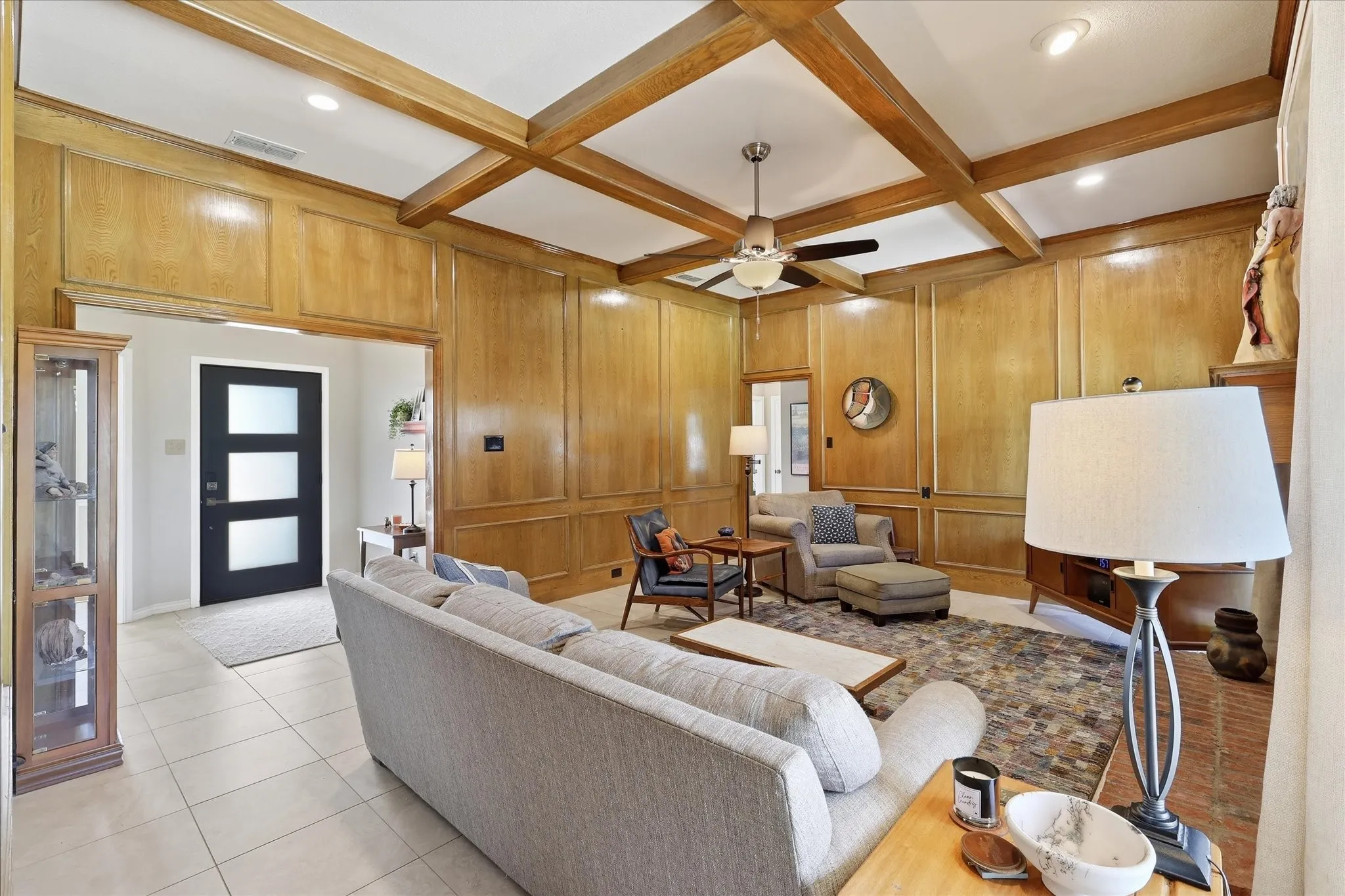 Picture frame paneling and decorative beams make this a warm and cozy living space.
