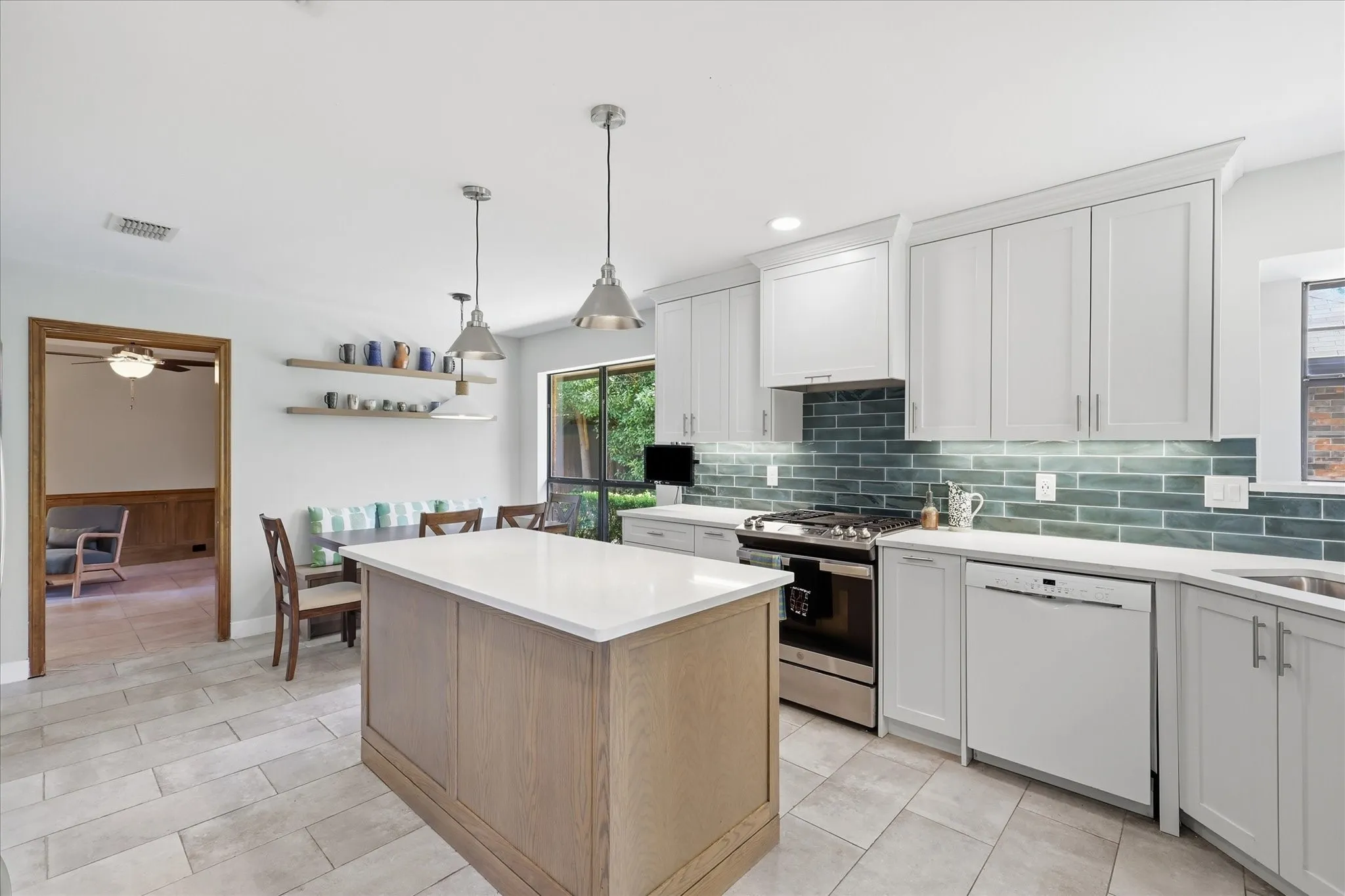 Cook with gas and allow the above vent to do it's job and vent to the outside.  The vent hood does open and allow for additional storage.