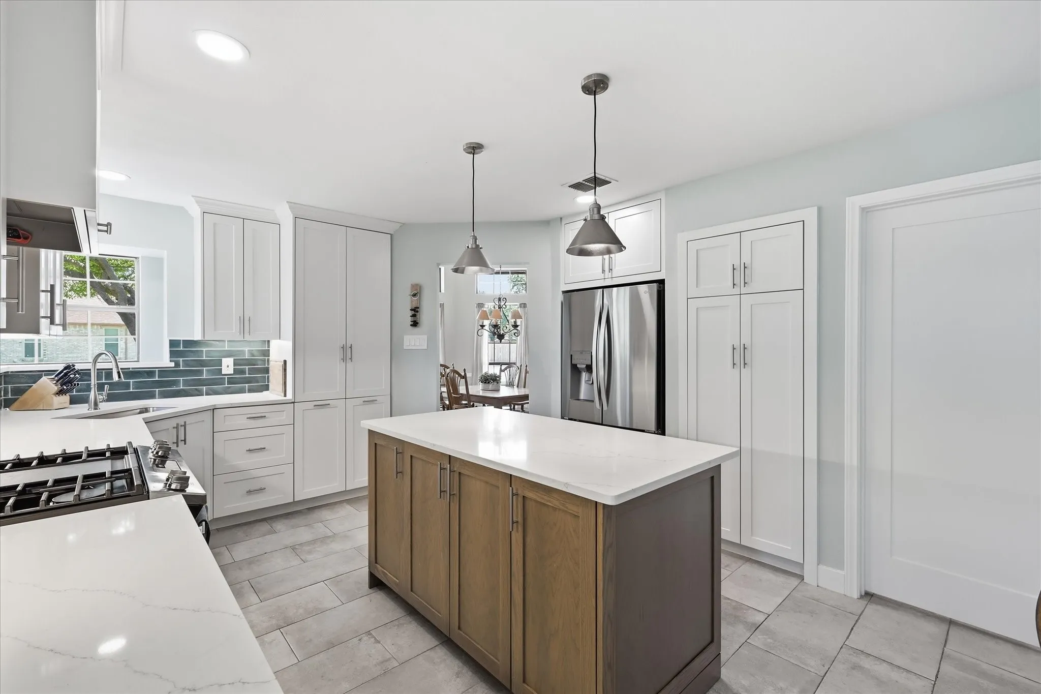 Remodeled kitchen offers an appliance garage and pantry.  42" cabinet uppers allow for much additional storage.  Next to the refrigerator is the built in pantry.