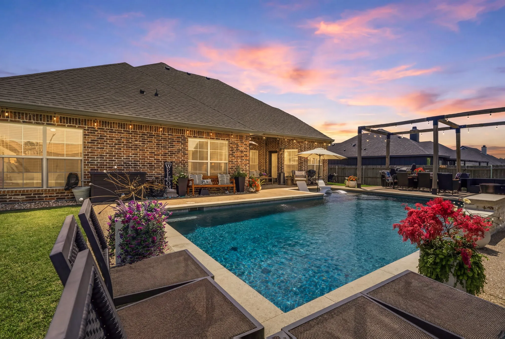 Private backyard oasis featuring a sparkling inground pool with integrated spa