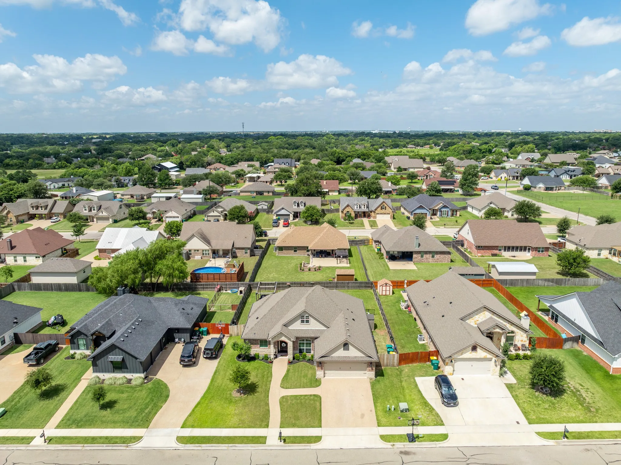 Suburban neighborhood featuring a variety of single-story homes, established landscaping, and paved streets