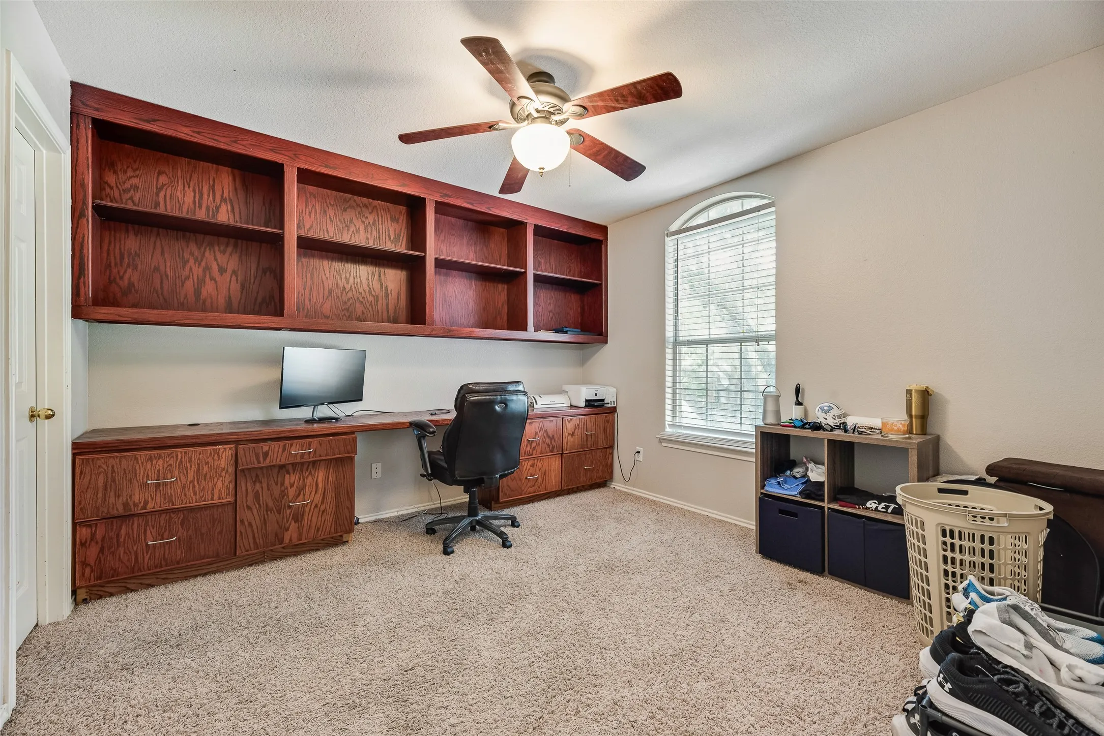 Built-in wood-finish cabinetry and shelving unit