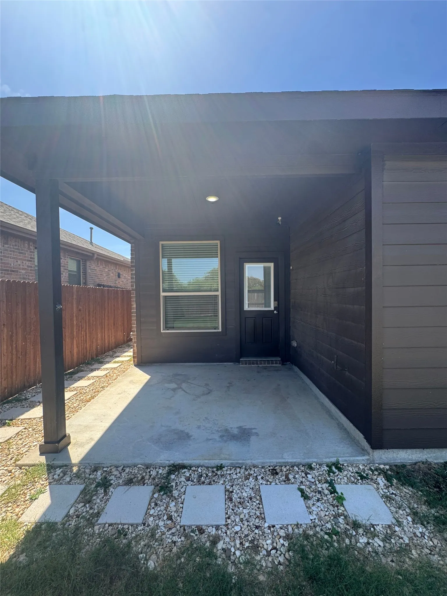 Covered patio with a concrete slab, recessed lighting, and a privacy fence