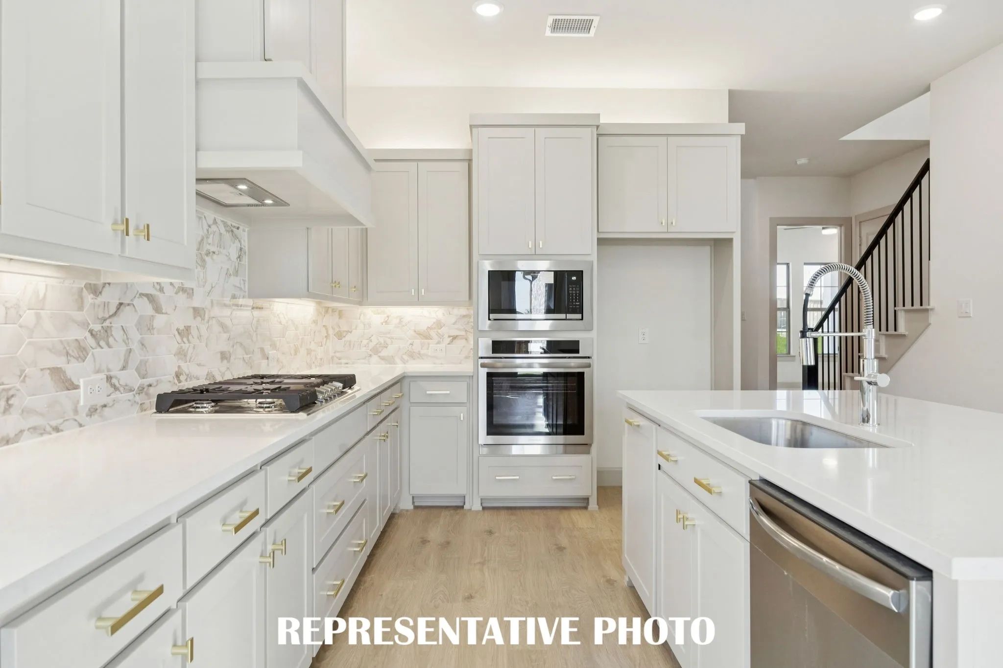 With beautiful cabinetry, gorgeous counter tops, elegant backsplash and stainless appliances, this dream kitchen is all that and more!  REPRESENTATIVE PHOTO