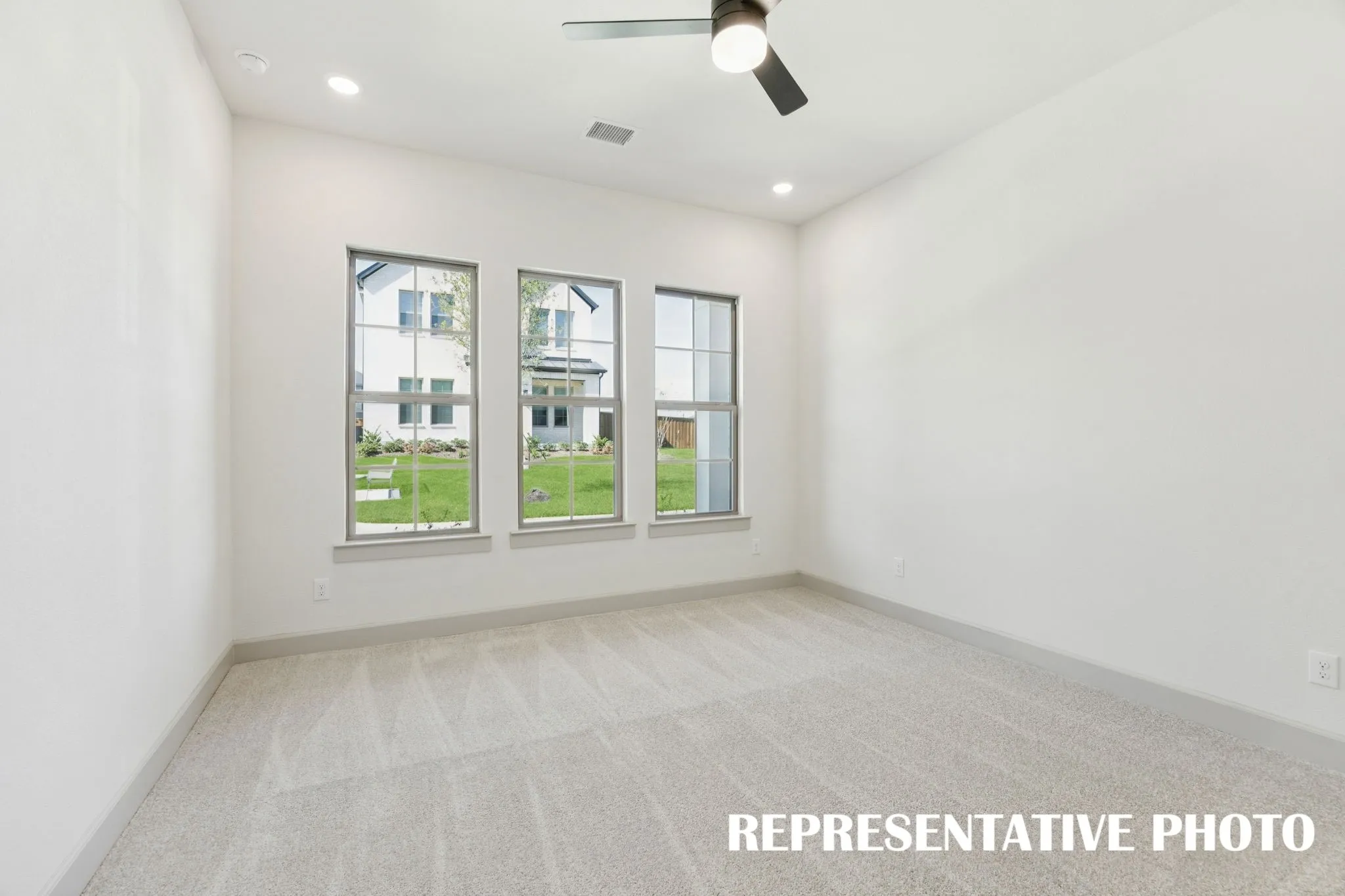 Featuring a wall of windows, this peaceful and relaxing owner's suite is waiting for you to call it home!  REPRESENTATIVE PHOTO