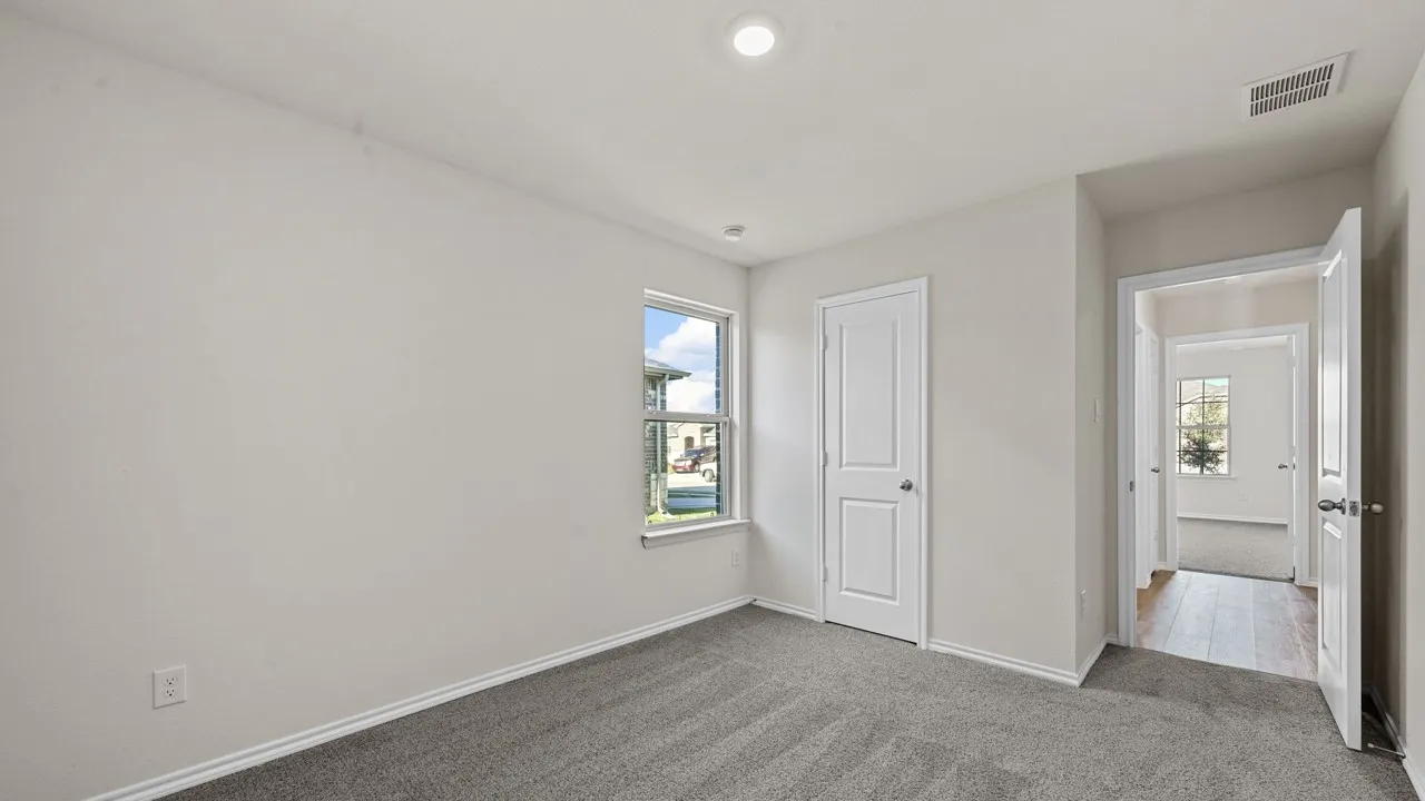 Carpeted room with a single window, white walls, and white trim
