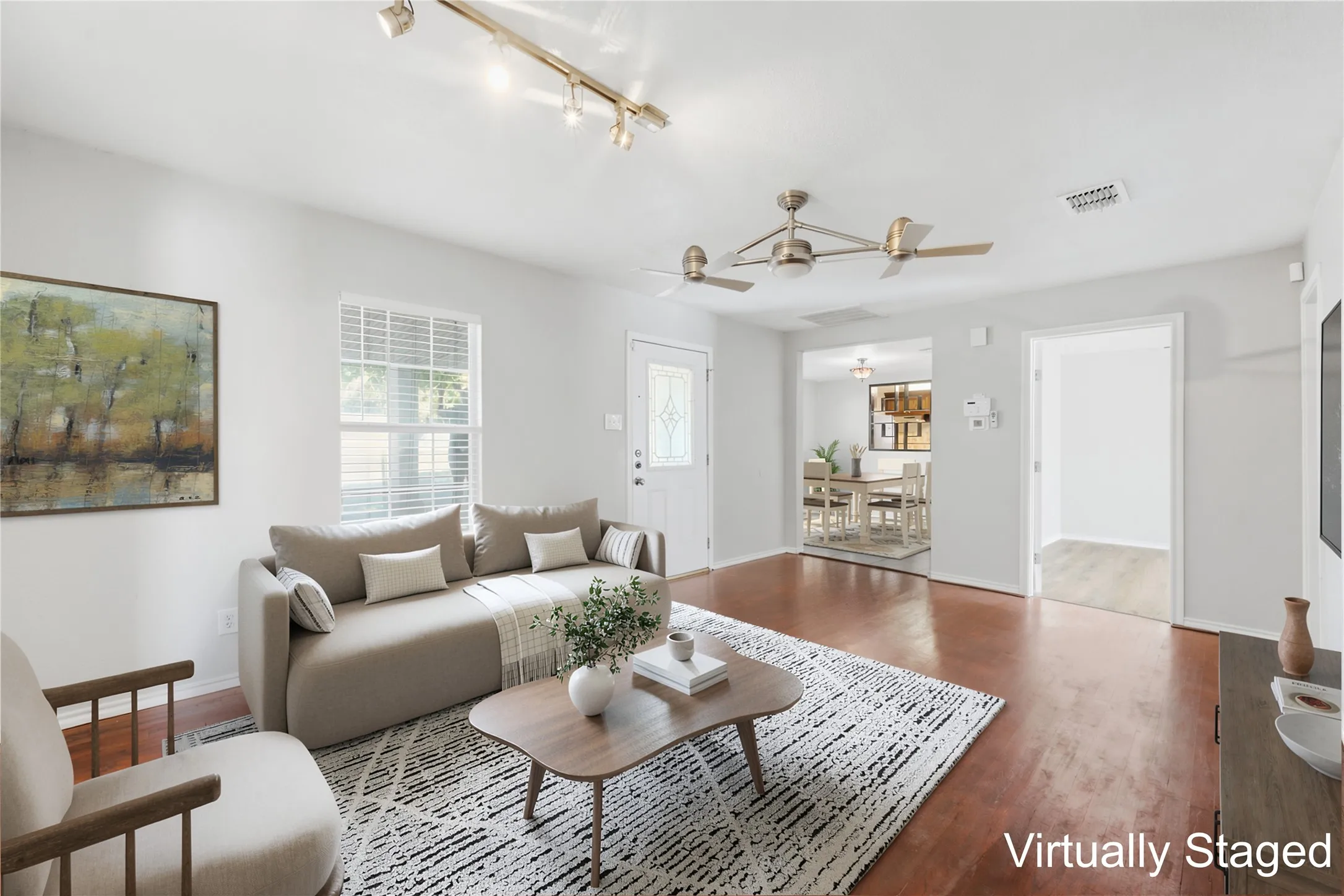 Virtually staged living room with dining room in the background