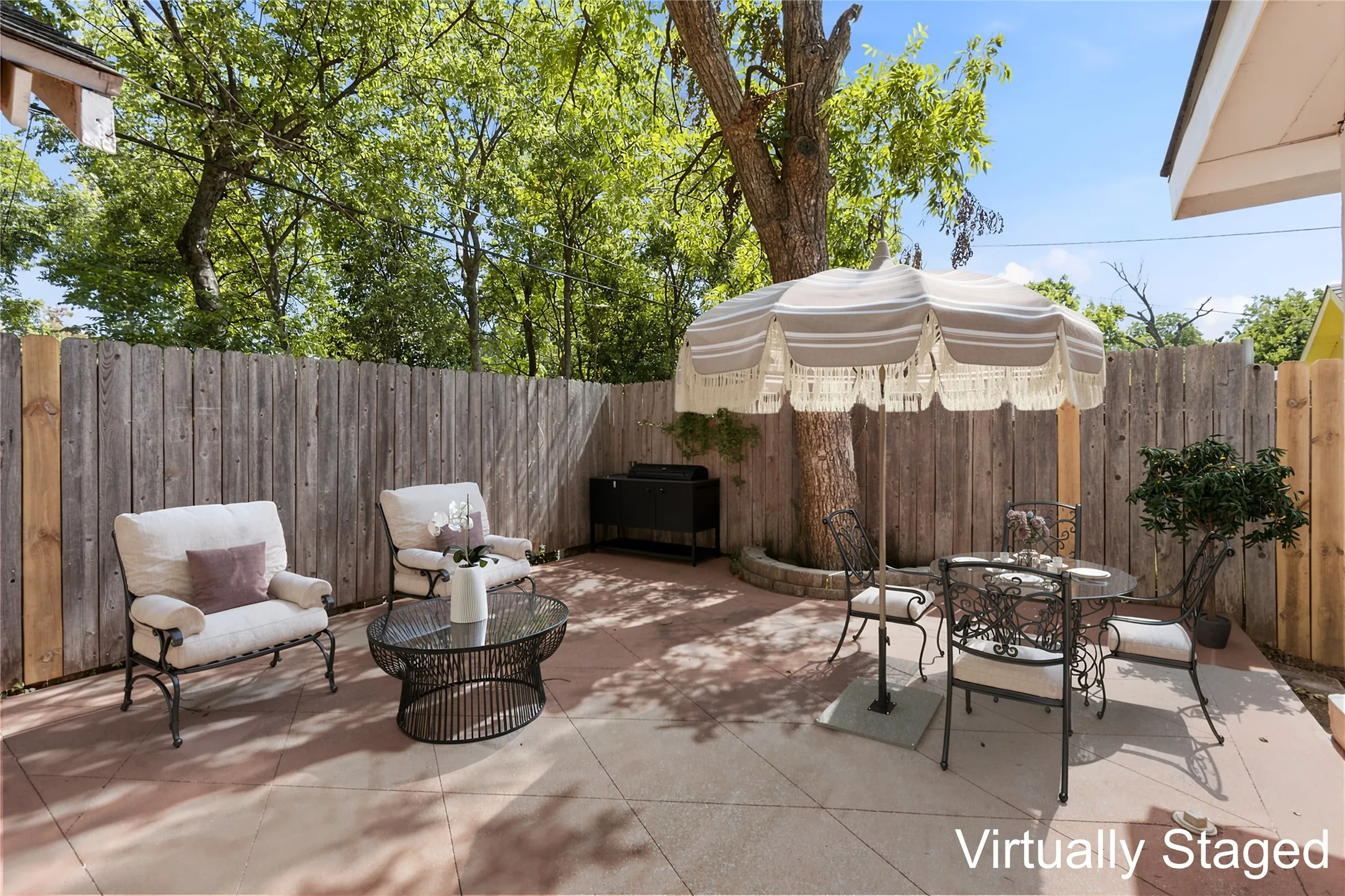 Virtually staged private patio area located by the kitchen door and 1-car garage