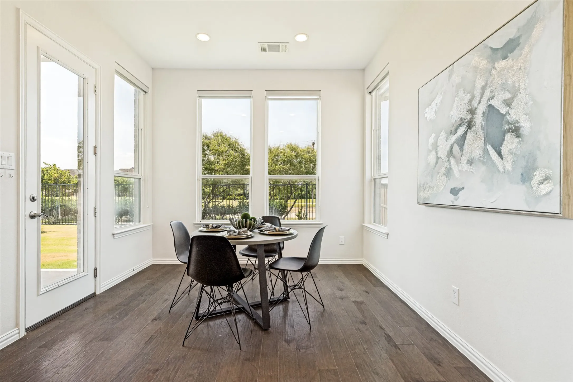 Dining area featuring dark wood-finish flooring, recessed lighting, and white baseboards
