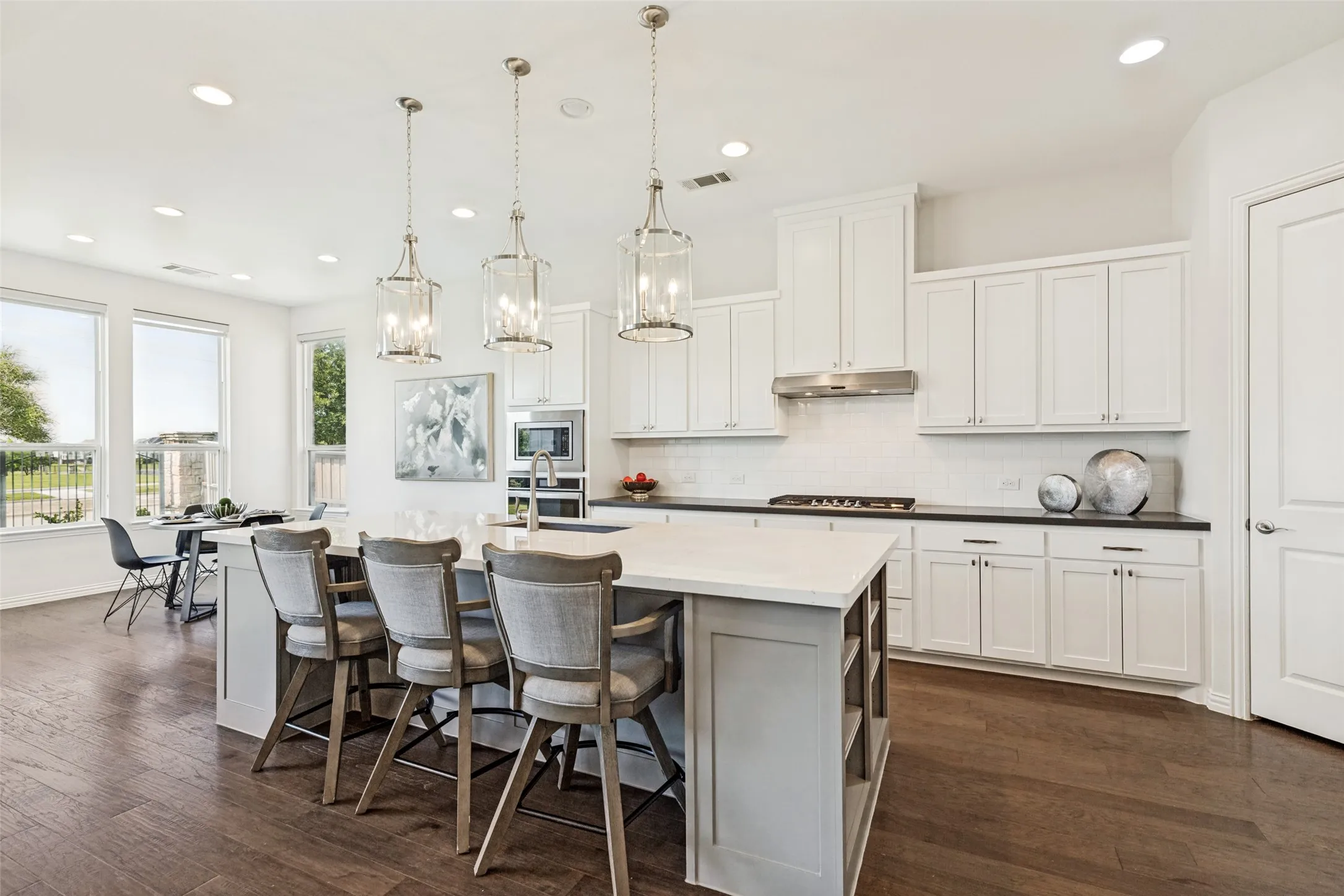 Kitchen with a large island featuring pendant lighting and seating