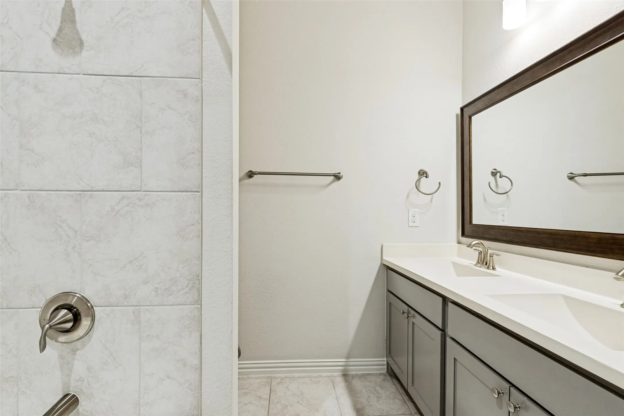 Dual vanity featuring an integrated rectangular sink and brushed nickel faucet