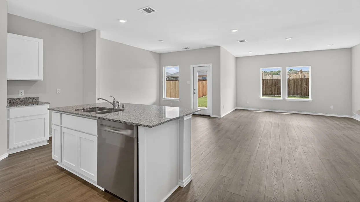 Open-concept living space featuring wood-finish flooring, recessed lighting, and light gray wall paint