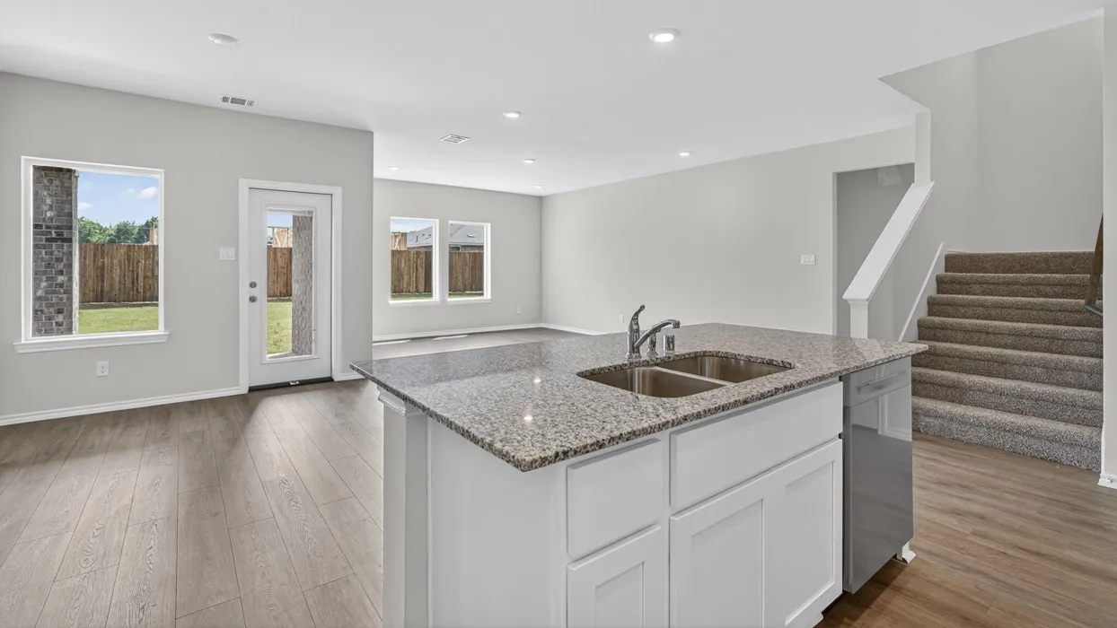 Kitchen island with a double basin sink and granite countertop