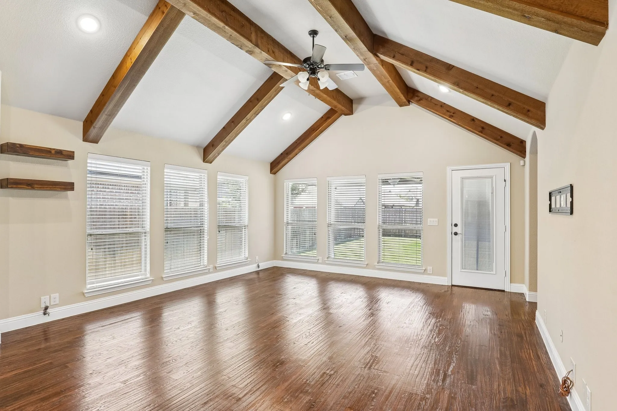 Vaulted ceiling featuring exposed wood beams