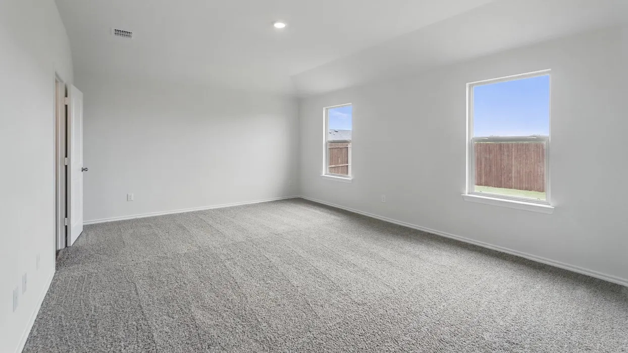 Spacious room with new gray carpet, white walls, two windows, and a flush-mount ceiling light